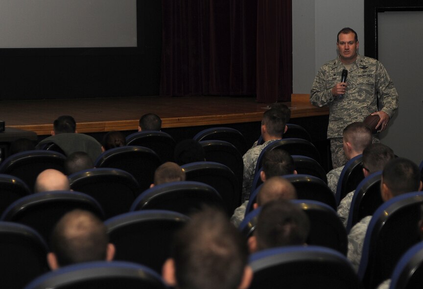 U.S. Air Force Col. Kenneth T. Bibb Jr., 100th Air Refueling Wing commander, speaks to 100th ARW Airmen during a commander’s call Nov. 12, 2014, at the base theater on RAF Mildenhall, England. Bibb urged Airmen to go back to basics and focus on the Air Force core values, readiness, fitness and safety to ensure continued mission success. (U.S. Air Force photo by Staff Sgt. Rachel Waller/Released)
