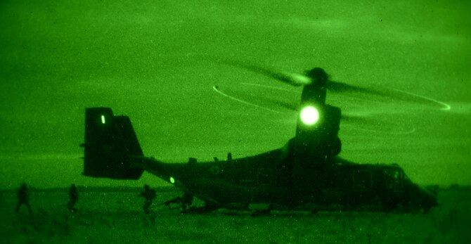 U.S. Air Force Air Commandos from the 321st Special Tactics Squadron, along with host nation partners, infiltrate an area from a CV-22B from the 7th Special Operations Squadron Nov. 6, 2014, during a training mission at RAF Sculthorpe in Norwich, England. During the mission, Air Commandos searched for simulated potential threats and rescued simulated hostages in the training area. (U.S. Air Force photo by Airman 1st Class Dillon Johnston/Released)