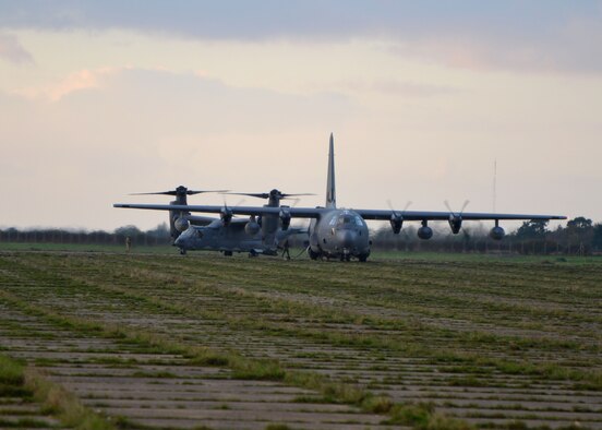 An MC-130J Commando II from the 67th Special Operations Squadron provides JP-8 fuel for a CV-22B Osprey during a forward area refueling point mission Nov. 5, 2014, at RAF Sculthorpe in Norwich, England. FARP supplies enough JP8 to an aircraft in need of fuel in order for them to reach a safe destination. This training is crucial for aircraft in forward deployed locations without the benefit of base fuel points. (U.S. Air Force photo by Tech. Sgt. Stacia Zachary/Released) 