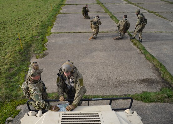 U.S. Air Force Air Commandos and host nation partners consult a map to orient themselves and come up with a plan of action Nov. 5, 2014, during a training mission at RAF Sculthorpe in Norwich, England. During the training mission, Air Commandos searched for simulated potential threats and rescued simulated hostages in the training area. (U.S. Air Force photo by Tech. Sgt. Stacia Zachary/Released)