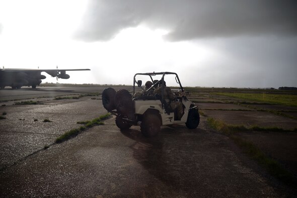 Air Commandos from the 321st Special Tactics Squadron exit an MC-130J from the 67th Special Operations Squadron on a Light Armored Tactical Vehicle Nov. 5, 2014, during a training mission at RAF Sculthorpe in Norwich, England. During the training mission, Air Commandos searched for simulated potential threats and rescued simulated hostages in the training area. (U.S. Air Force photo by Tech. Sgt. Stacia Zachary/Released)
