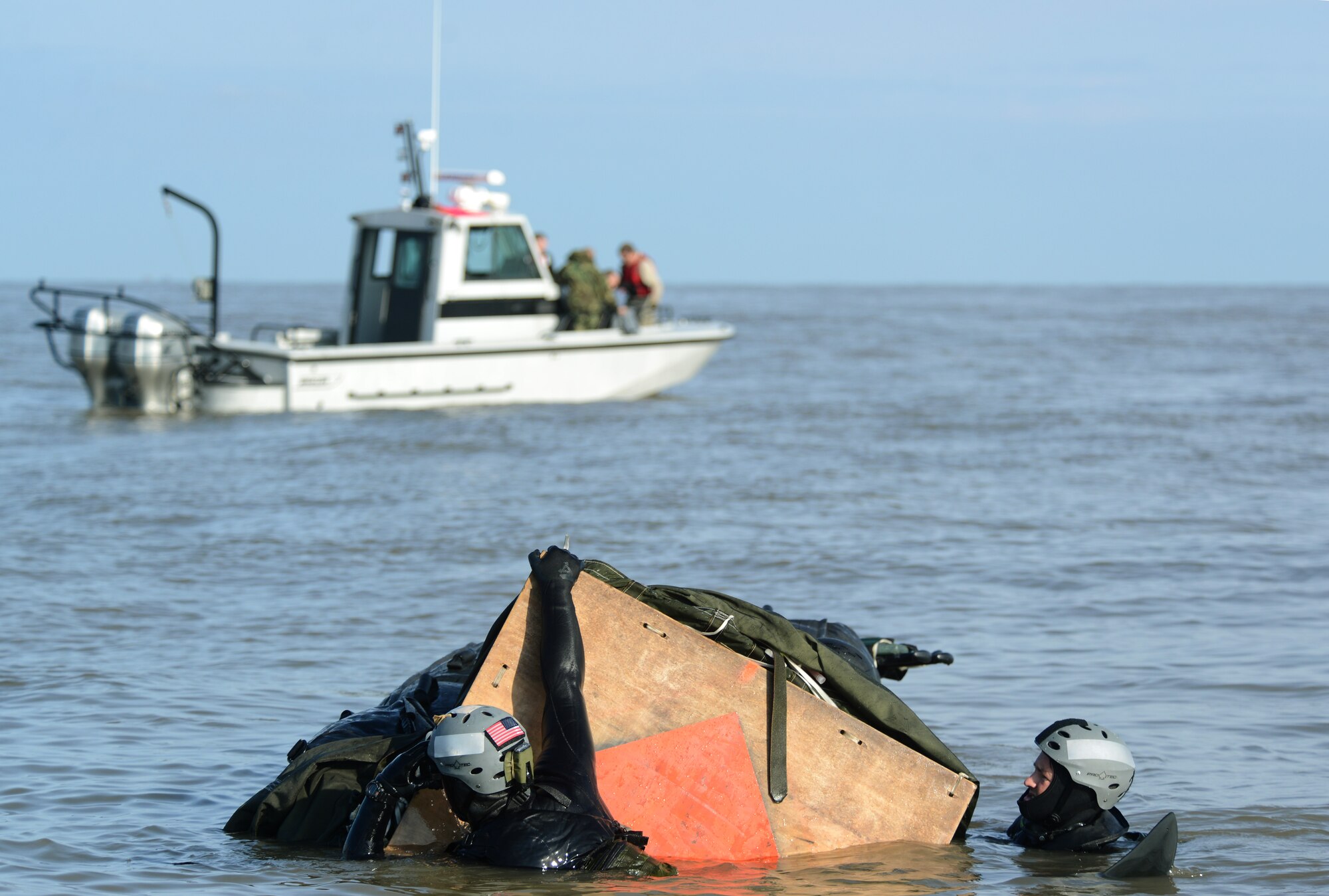 Air Commandos from the 321st Special Tactics Squadron, RAF Mildenhall, and the 56th Rescue Squadron, RAF Lakenheath, retrieve a zodiac boat after jumping from an MC-130J Commando II into the water off the coastline of Ipswich, England, Nov. 4, 2014. The Air Commandos conducted amphibious special operations procedures throughout the week. (U.S. Air Force photo by Airman 1st Class Dillon Johnston/Released)
