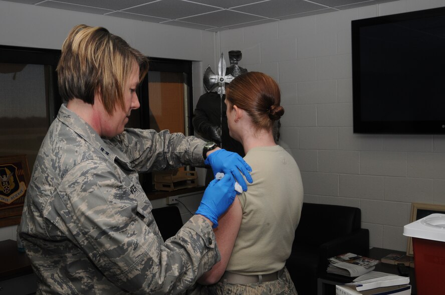 Capt. Jamey Weaver, a nurse assigned to the 910th Medical Squadron, administers a flu shot to Staff Sgt. Debbie Boles, an evaluations specialist for the 910th Force Support Squadron Military Personnel Flight here, Nov. 2, 2014. It is an annual requirement for Department of Defense military personnel to receive the flu show to help ensure their medical readiness to deploy and carry out missions anywhere around the globe. U.S. Air Force photo by Tech. Sgt. Rick Lisum 