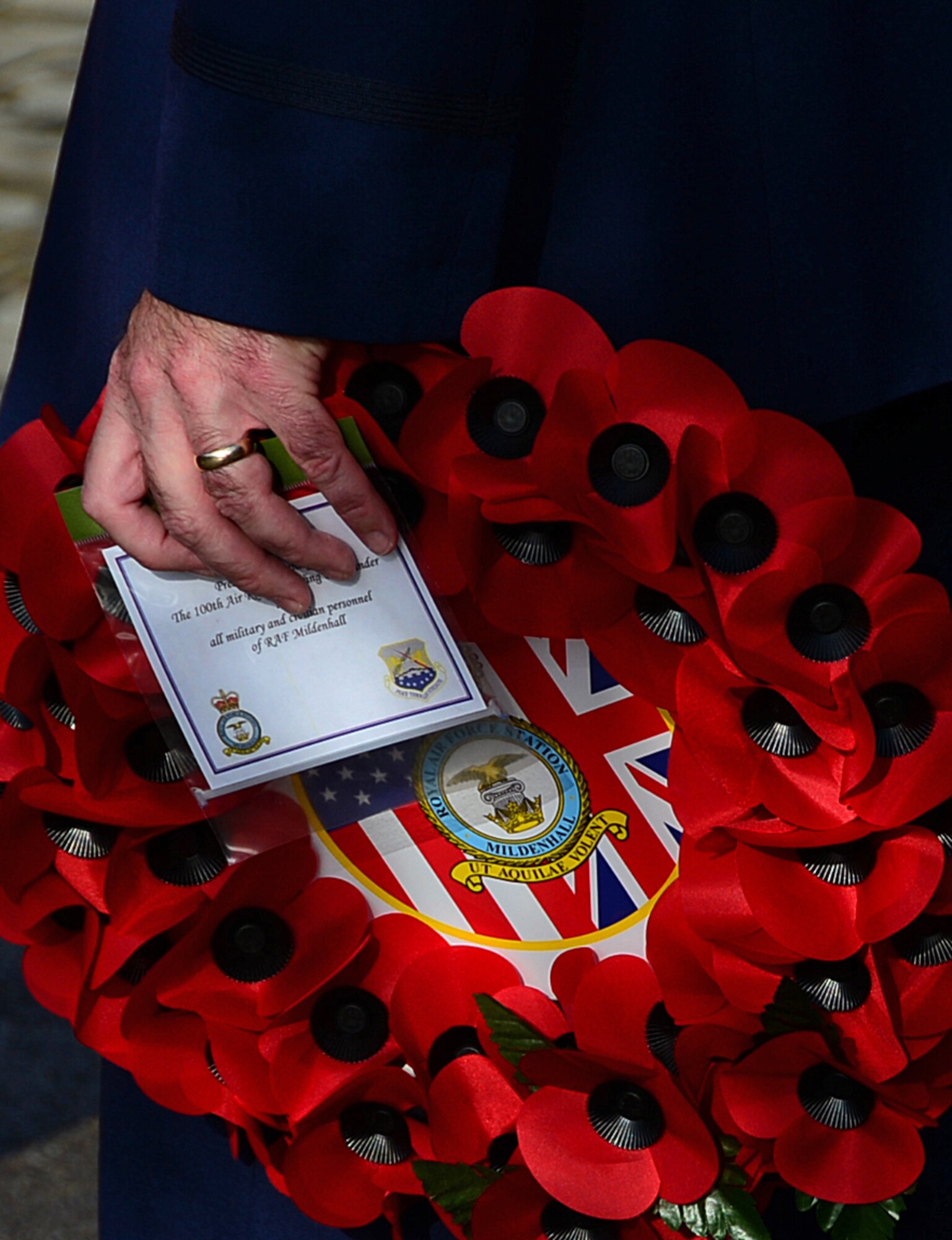 Col. Kenneth Bibb, 100th Air Refueling Wing commander, holds a poppy wreath during the Remembrance Day ceremony in Bury St. Edmunds, England, Nov. 9, 2014. Airmen from RAFs Lakenheath and Mildenhall participated in the ceremony by laying poppy wreaths to show their reverence to fallen heroes. (U.S. Air Force photo by Senior Airman Erin O’Shea/Released)