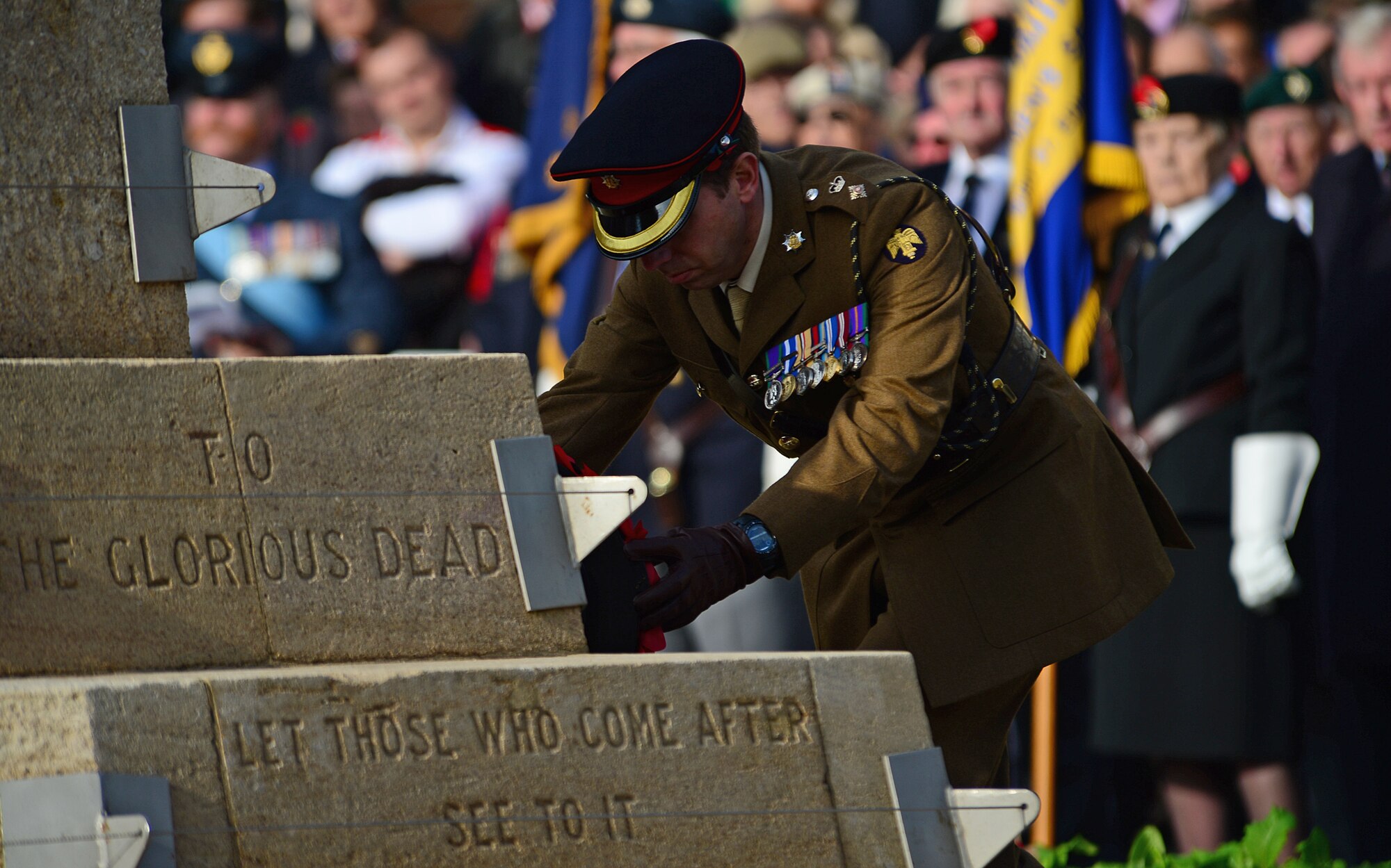 A British military representative lays a poppy wreath on the Angel Hill War Memorial during the Remembrance Day ceremony in Bury St. Edmunds, England, Nov. 9, 2014. Each year, a ceremony is held where military and community participants lay poppy wreaths to show their respect and reverence to fallen heroes. (U.S. Air Force photo by Senior Airman Erin O’Shea/Released) 