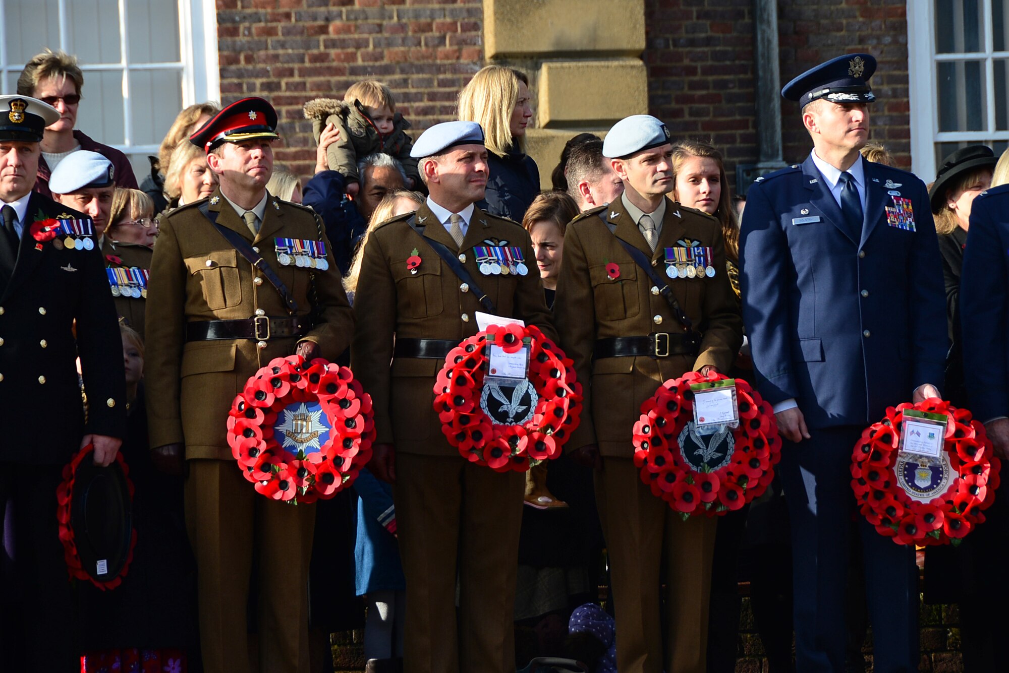 Col. Robert Novotny (right), 48th Fighter Wing commander, stands with British military representatives during the Remembrance Day ceremony on Angel Hill in Bury St. Edmunds, England, Nov. 9, 2014. Airmen from RAFs Lakenheath and Mildenhall participated in the ceremony by laying poppy wreaths to show their support and reverence to fallen heroes. (U.S. Air Force photo by Senior Airman Erin O’Shea/Released) 