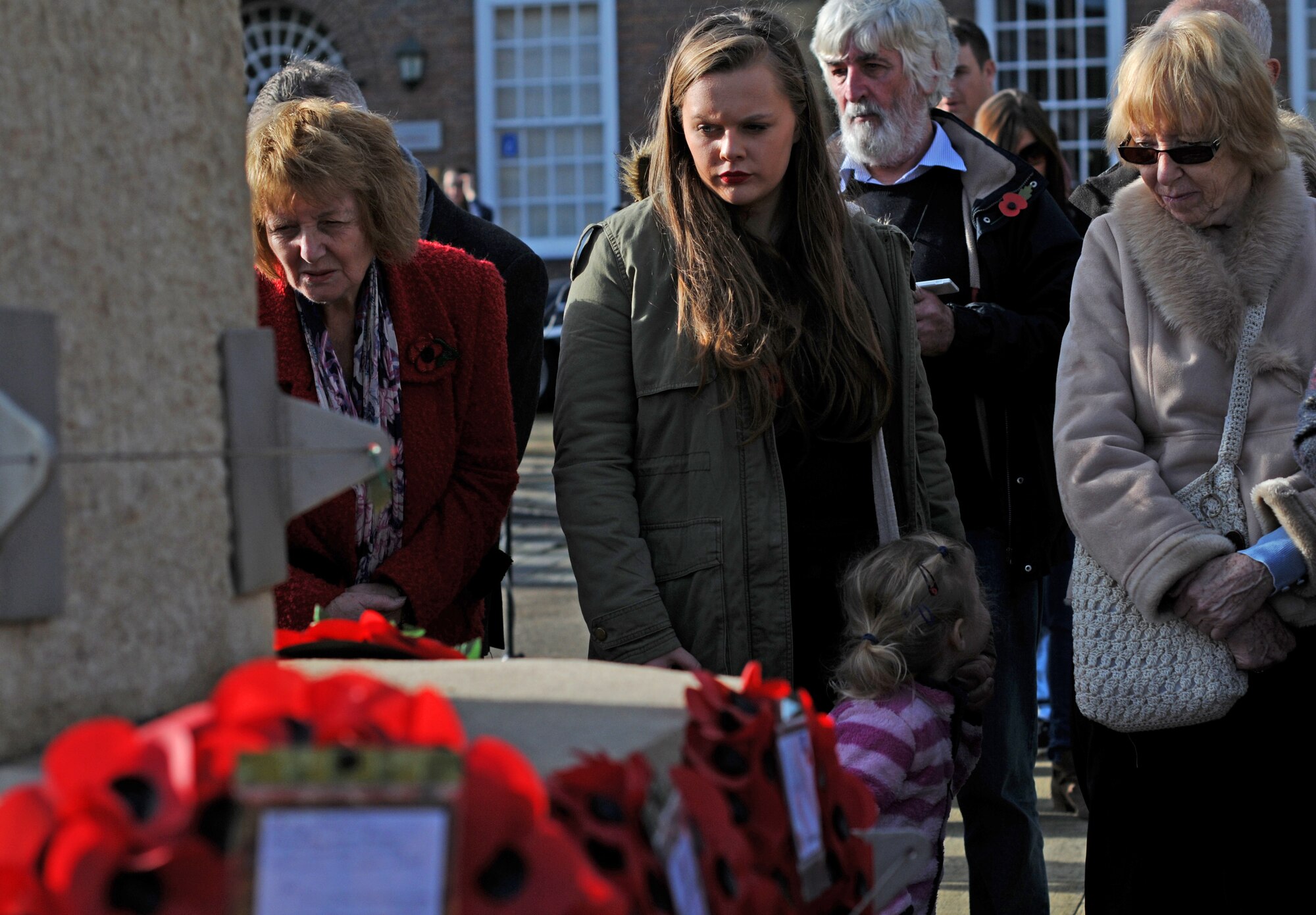 Local community members visit wreaths on the Angel Hill War Memorial during a Remembrance Day ceremony in Bury St. Edmunds, England, Nov. 9, 2014. Airmen from RAF’s Lakenheath and Mildenhall participated in the ceremony by laying poppy wreaths to show their reverence to fallen heroes. (U.S. Air Force photo by Senior Airman Erin O’Shea/Released) 