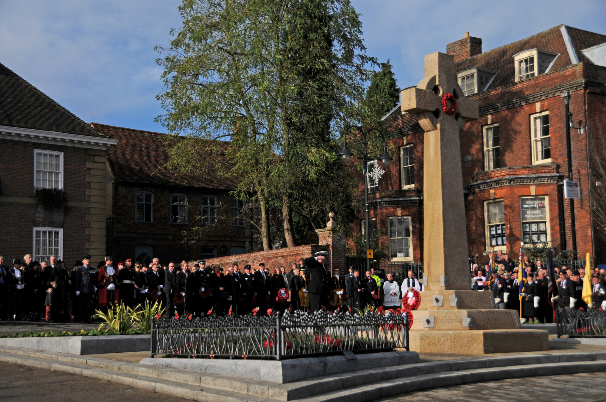 Local community members, along with U.S. and British military representatives, gather on Angel Hill in Bury St. Edmunds, England, Nov. 9, 2014, to pay respect to fallen heroes on Remembrance Day. Airmen from RAFs Lakenheath and Mildenhall participated in the ceremony by laying poppy wreaths to show their reverence. (U.S. Air Force photo by Senior Airman Erin O’Shea/Released)