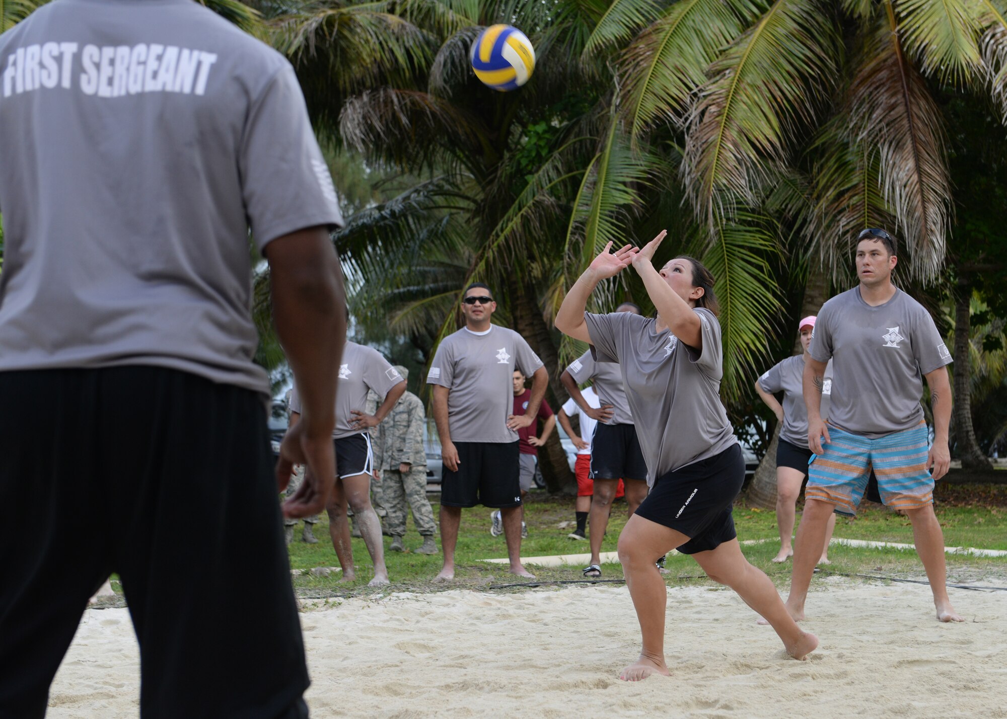 Senior Master Sgt. Rena Banes, 36th Civil Engineer Squadron first sergeant, sets the ball during a commanders vs. first sergeants beach volleyball game Nov. 7, 2014, at Tarague Beach at Andersen Air Force Base, Guam.  The game was a part of an ongoing competitive series between the two base leadership groups. (U.S. Air Force photo by Senior Airman Katrina M. Brisbin/Released)