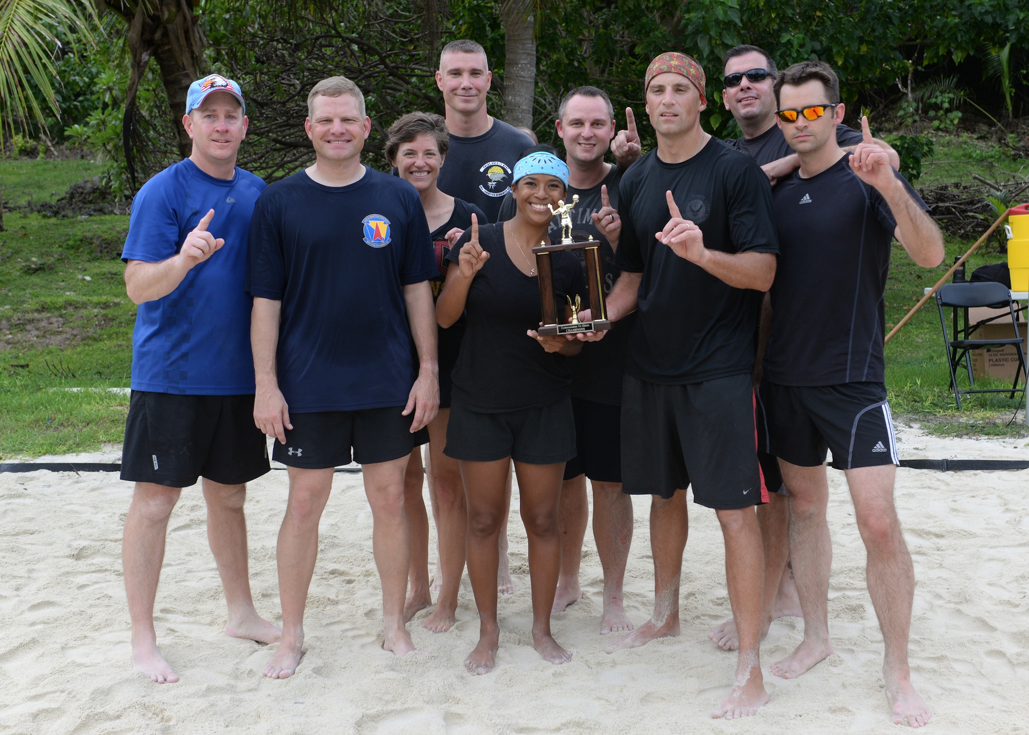 Team Andersen commanders stand together after winning a commanders vs. first sergeants beach volleyball game Nov. 7, 2014, at Tarague Beach at Andersen Air Force Base, Guam. The commanders beat the first sergeants in a best of three tournament style volleyball game and secured possession of the trophy until the next event. (U.S. Air Force photo by Senior Airman Katrina M. Brisbin/Released)