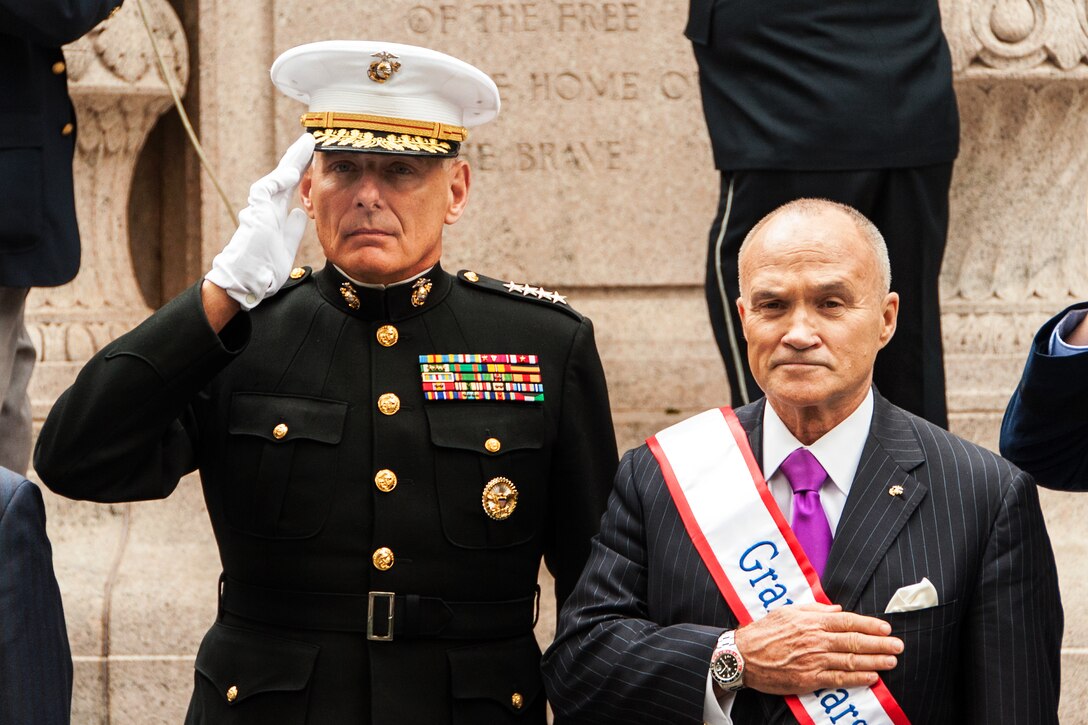 Marine Corps Gen. John F. Kelly, left, commander, U.S. Southern Command, and retired U.S. Marine Corps Col. Ray Kelly, who is a former New York City Police commissioner, render honors during a wreath-laying ceremony before the start of the 95th Annual New York City Veterans Day Parade in New York, Nov. 11, 2014.