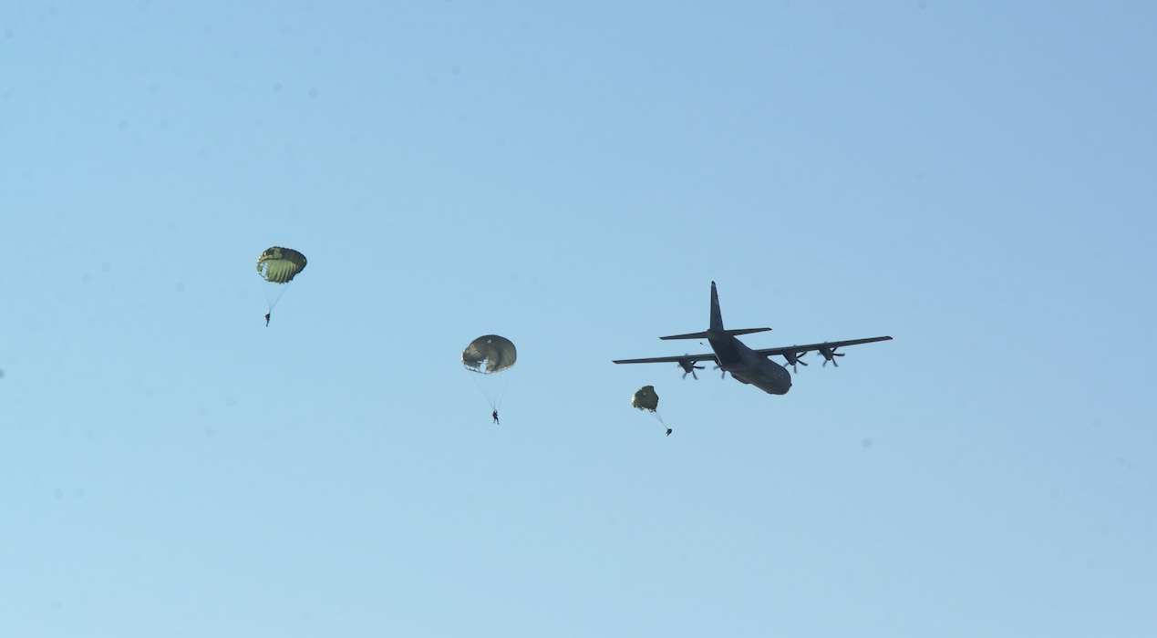 As an MC-130J Commando II from the 67th Special Operations Squadron passes over the water drop zone, Air Commandos from the 321st Special Tactics Squadron, RAF Mildenhall, and the 56th Rescue Squadron, RAF Lakenheath, drop into the water off the coastline of Ipswich, England, Nov. 4, 2014. The Air Commandos conducted amphibious special operations procedures during a water training exercise. (U.S. Air Force photo by Airman 1st Class Dillon Johnston/Released)