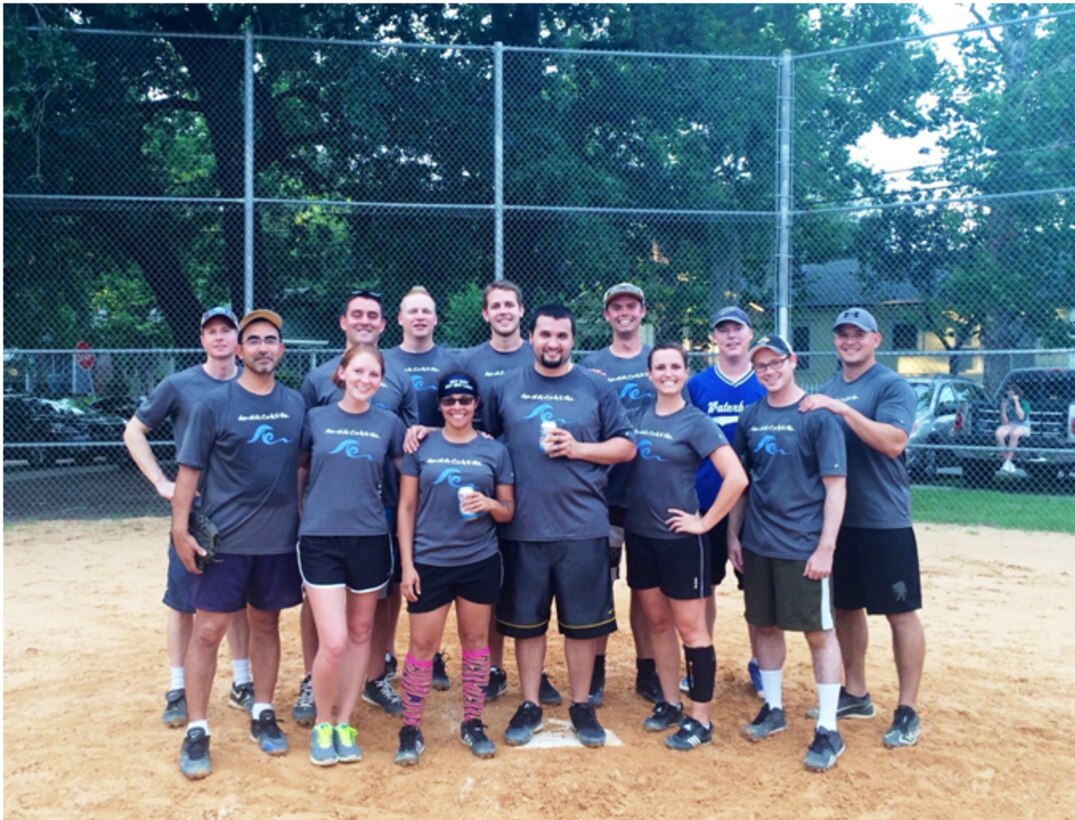 Ms. Vicinie (front row, second from the left) participated in a Jacksonville District softball team while she was on detail there.