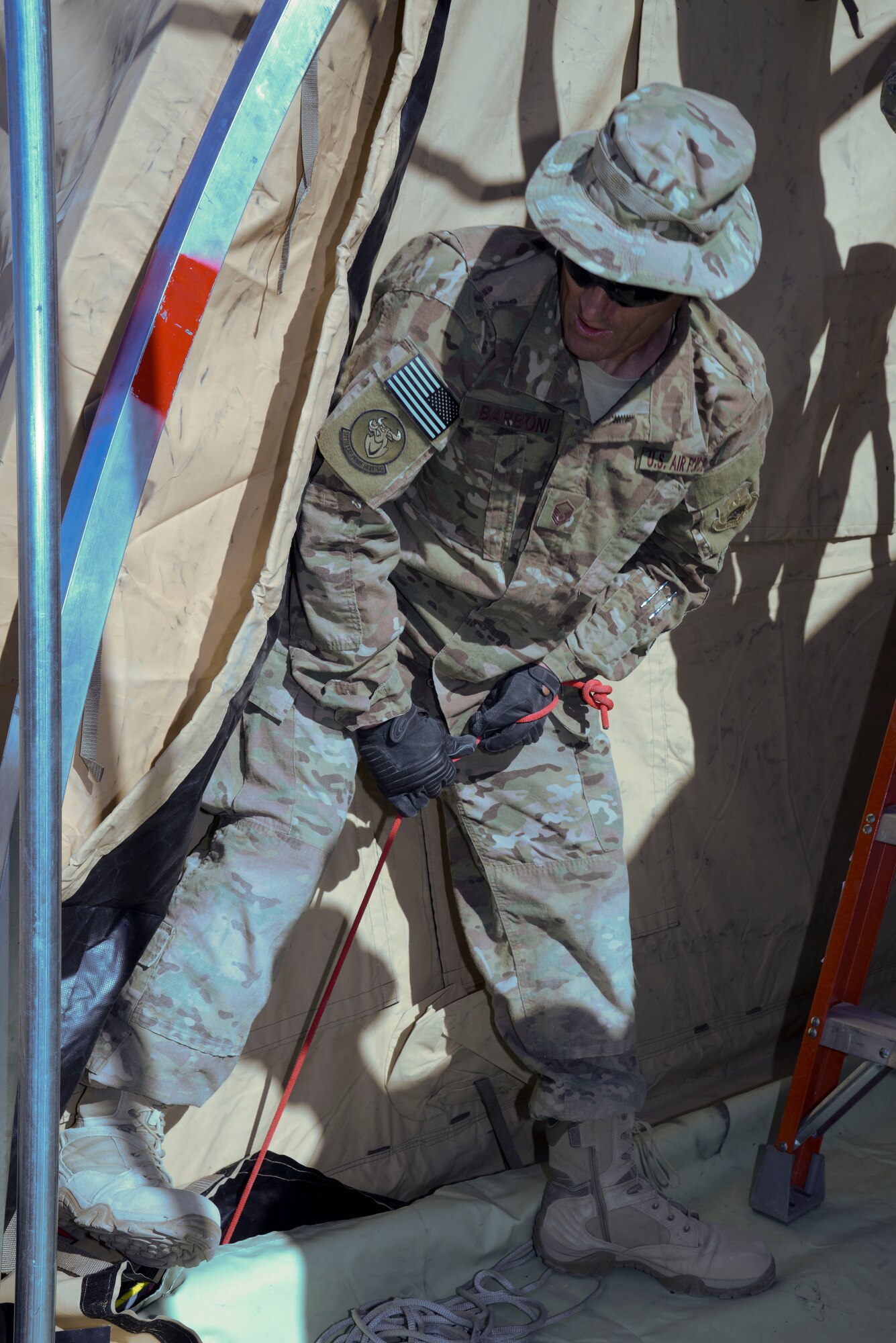 Master Sgt. John Barboni, 577th Expeditionary Prime Base Engineer Emergency Force Squadron, pulls the slack out of the canvas on one of four medical tents here Nov. 7, 2014. The four tents will serve as an Expeditionary Medical Support site to support the growing number of joint and coalition forces supporting Operation Inherent Resolve in the region.(U.S. Air Force photo by Tech. Sgt. Jared Marquis/released)