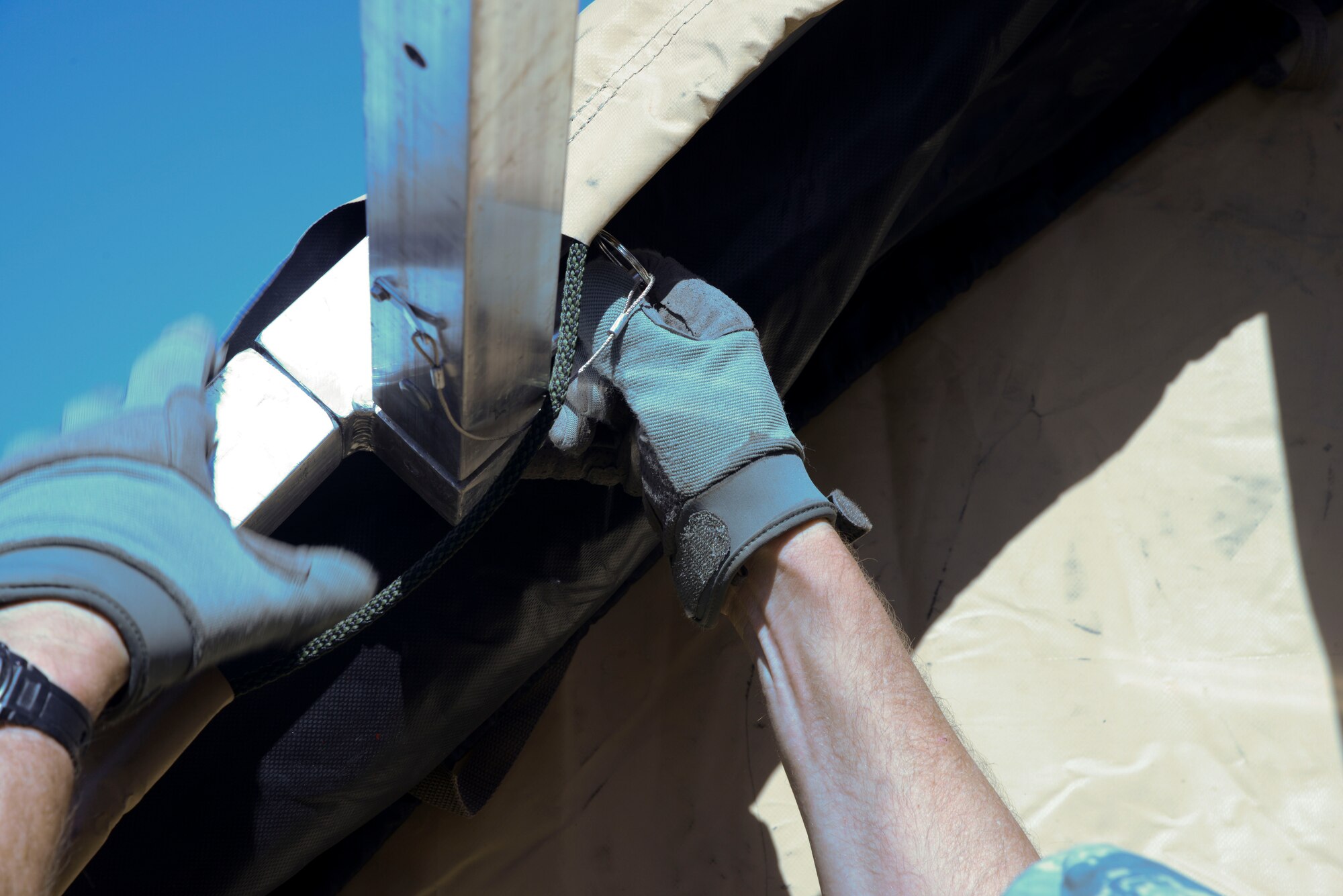 An Airman attaches the canvas on one of four medical tents here Nov. 7, 2014. The four tents will serve as an Expeditionary Medical Support site to support the growing number of joint and coalition forces supporting Operation Inherent Resolve in the region. (U.S. Air Force photo by Tech. Sgt. Jared Marquis/released)