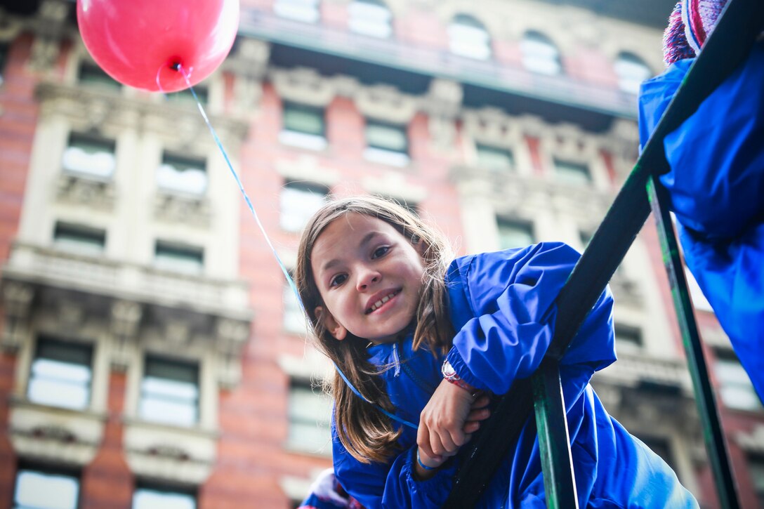 A young child poses for a photo during the 95th Annual Veterans Day Parade in Manhattan, N.Y., Nov.11, 2014. In addition to the parades service members, more than  6,000 people were in attendance. (U.S. Marine Corps photo by Cpl. Elizabeth Thurston/Released)