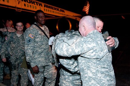 Georgia Guardsmen from Springfield's Battery A, 1st Battalion, 118th Field Artillery embrace each other after arriving safely back in Georgia at Savannah's Hunter Army Airfield. The more than 100 artillerymen spent a year in Afghanistan helping the Afghan army and National Police become more efficient at taking over the security of their country.