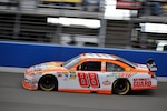 Dale Earnhardt Jr., (left) drives the No. 88 National Guard-sponsored NASCAR race car Feb. 21 at Fontana Speedway, Calif.