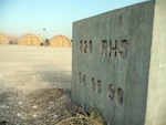 A concrete block etched with "820th RED HORSE Squadron" stands near the camp of the 24th Air Expeditionary Group at Toussaint L'Ouverture International Airport in Port-au-Prince, Haiti. The 820th RED HORSE Squadron Airmen spent time in Haiti in 1994, 1995 and 1996, helping the country build basic infrastructure.