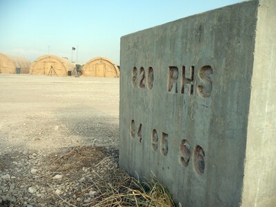 A concrete block etched with "820th RED HORSE Squadron" stands near the camp of the 24th Air Expeditionary Group at Toussaint L'Ouverture International Airport in Port-au-Prince, Haiti. The 820th RED HORSE Squadron Airmen spent time in Haiti in 1994, 1995 and 1996, helping the country build basic infrastructure.