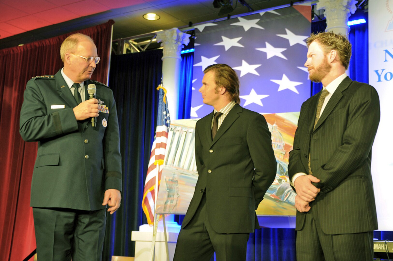 Air Force Gen. Craig McKinley, the chief of the National Guard Bureau; Indy 500 champion Dan Wheldon and NASCAR's Dale Earnhardt Jr. at the fifth annual ChalleNGe Champions Gala at the J.W. Marriott Hotel in Washington, D.C., on Feb. 23, 2010, to honor advocates of the National Guard Youth ChalleNGe Program, a 17-month voluntary intervention program that has graduated more than 92,850 former high dropouts since 1993.