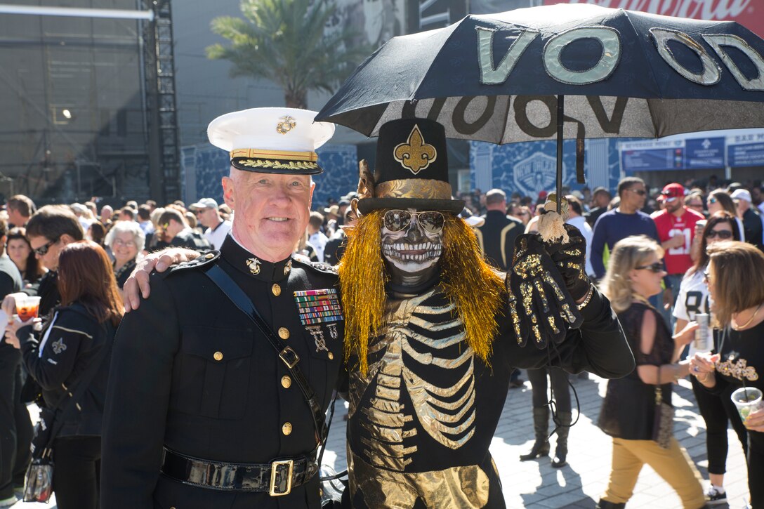 Lt. Gen. Richard P. Mills, commander of Marine Forces Reserve, poses for a photo with a New Orleans Saints fan during the Veteran Salute day at Champion Square in New Orleans, Nov. 9, 2014. Veteran Salute day is part of the National Football League’s annual Salute to Service campaign in which, throughout the month, teams designate one home game to honor the military.