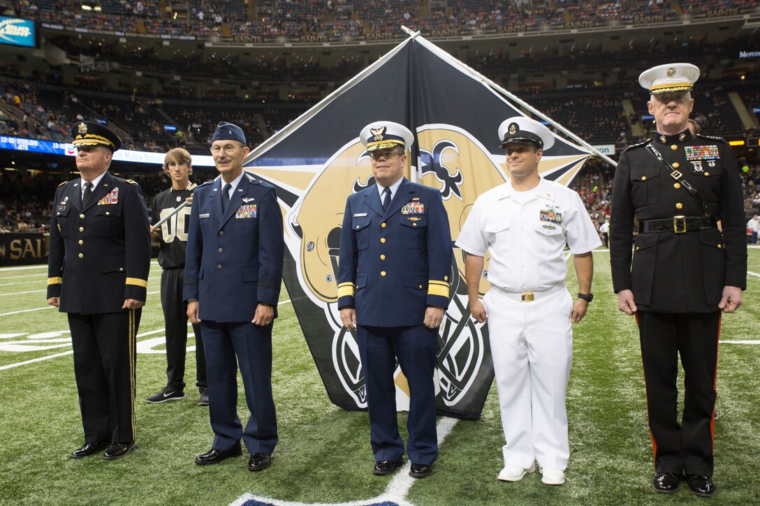 Lt. Gen. Richard P. Mills, commander of Marine Forces Reserve, and fellow military officers represent their service branch during a Veteran Salute day presentation at the Mercedes-Benz Superdome in New Orleans, Nov. 9, 2014. Veteran Salute day is part of the National Football League’s annual Salute to Service campaign in which, throughout the month, teams designate one home game to honor the military.