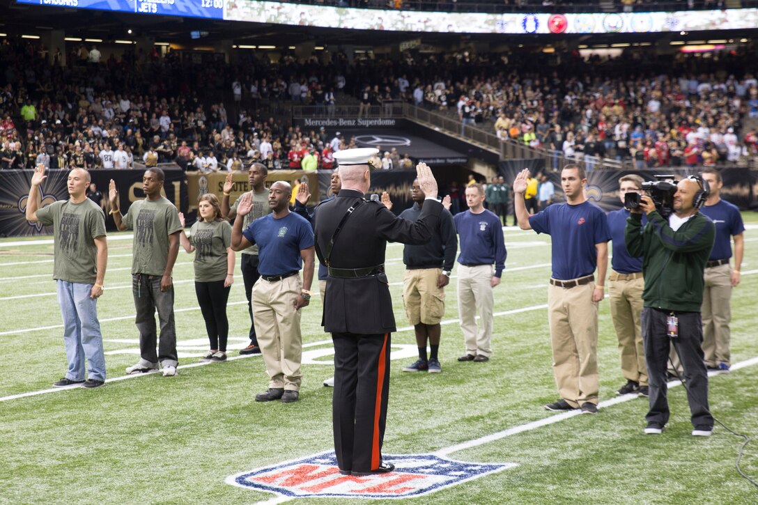 Lt. Gen. Richard P. Mills, commander of Marine Forces Reserve, conducts the enlistment ceremony for new Marine recruits at the Mercedes-Benz Superdome in New Orleans, Nov. 9, 2014. Upon joining the armed forces, each person takes an oath of enlistment swearing to support and defend the U.S. constitution. 