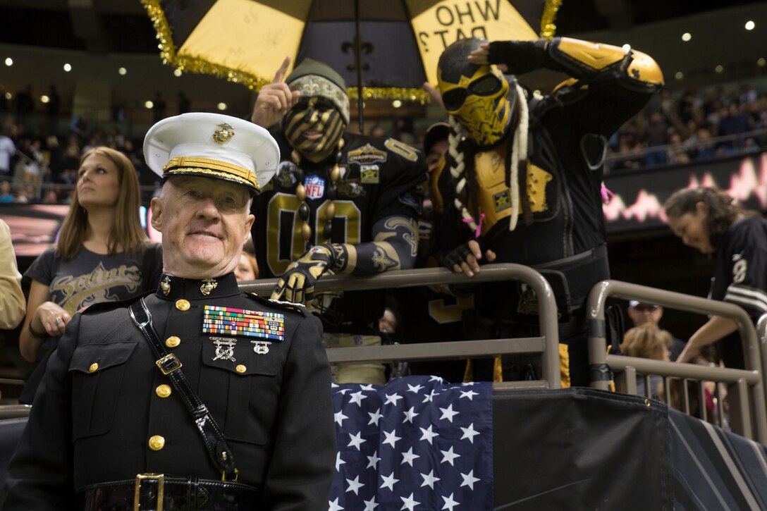 Lt. Gen. Richard P. Mills, commander of Marine Forces Reserve, poses for a photo with New Orleans Saints fans during the Veteran Salute day at Champion Square in New Orleans on Nov. 9, 2014. Veteran Salute day is part of the National Football League’s annual Salute to Service campaign in which, throughout November, teams designate one home game to honor the military.
