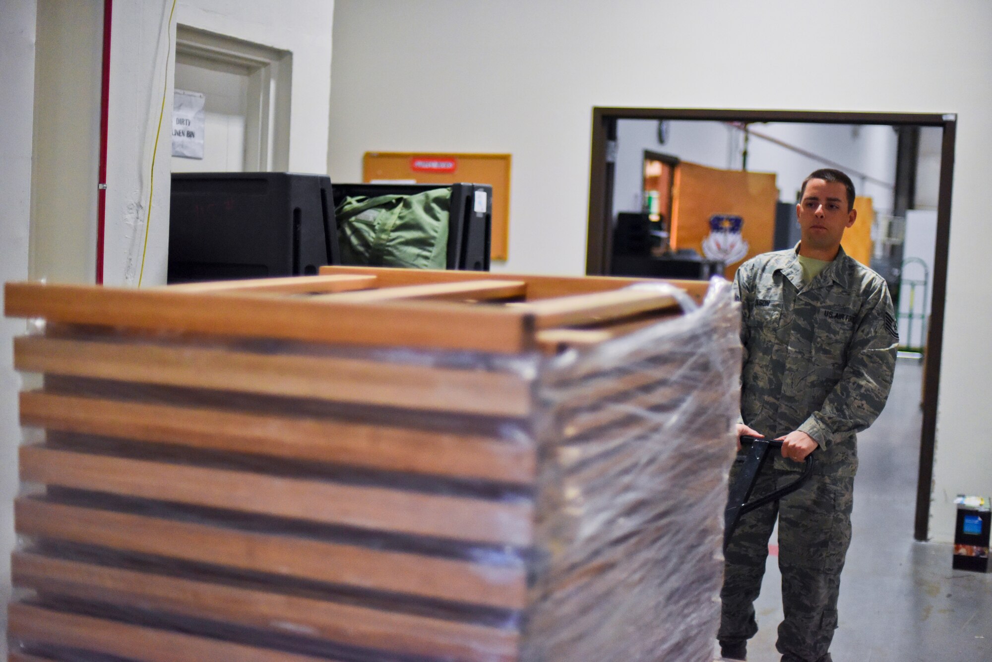 Tech. Sgt. Lee Olson transports new bed frames into a supply warehouse Oct. 20, 2014, at Malmstrom Air Force Base, Mont. Olson has personally ordered and distributed more than $400,000 worth of Force Improvement Program equipment to the base's missile complex. Olson is a 341st Operations Group supply coordinator. (U.S. Air Force photo/Airman 1st Class Collin Schmidt)