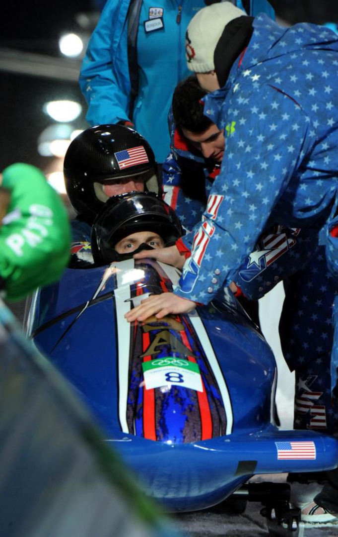 U.S. Army World Class Athlete Program bobsled pilot Sgt. John Napier and teammate Steve Langton are greeted at the finish line of the Olympic two-man bobsled finals at Whistler Sliding Centre Feb. 21, 2010. Napier drove USA II to a 10th-place finish with a four-run combined time of 3 minutes, 29.40 seconds.