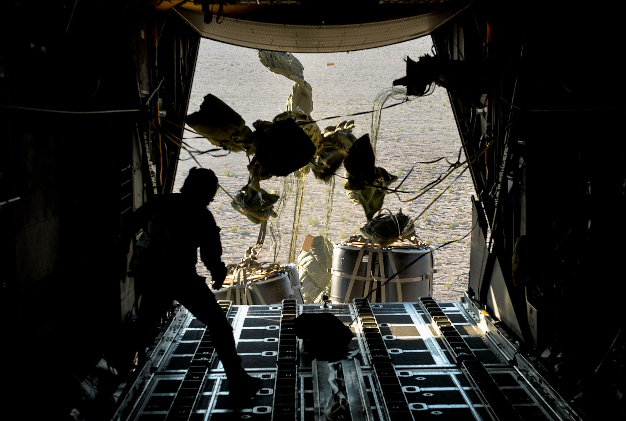 Staff Sgt. Sean Krumwiede, 15th Special Operations Squadron loadmaster, conducts an airdrop over San Clemente, Calif., during Exercise Carbonite Archer, Nov. 5, 2014. Carbonite Archer is an emergency deployment readiness exercise focusing on the 1st Special Operations Wing’s ability to deploy aircraft and personnel anytime and anywhere in the world. (U.S. Air Force photo/Senior Airman Christopher Callaway)