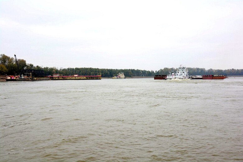 Fair Landing, Arkansas, Nov. 12, 2014 – Northbound commerce with as many as 49 barges moved through the restricted portion of the river at Fair Landing during daylight hours. This helps speed the clearing of the daily queue and reduces the wait time for southbound vessels. Work is also proceeding well in the narrowest reach of the restricted area and the Corps expects normal, unrestricted one-way traffic to resume after Monday, November 17, when the mat sinking unit completes its work in the narrow section and moves to a wider section of Fair Landing. (Photo by Eugene Wall)

