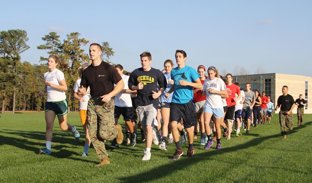 Capt. Zachary Smith leads athletes from Shawnee High School for a run during a leadership seminar at the high school in Medford, N.J., November 12, 2014. 