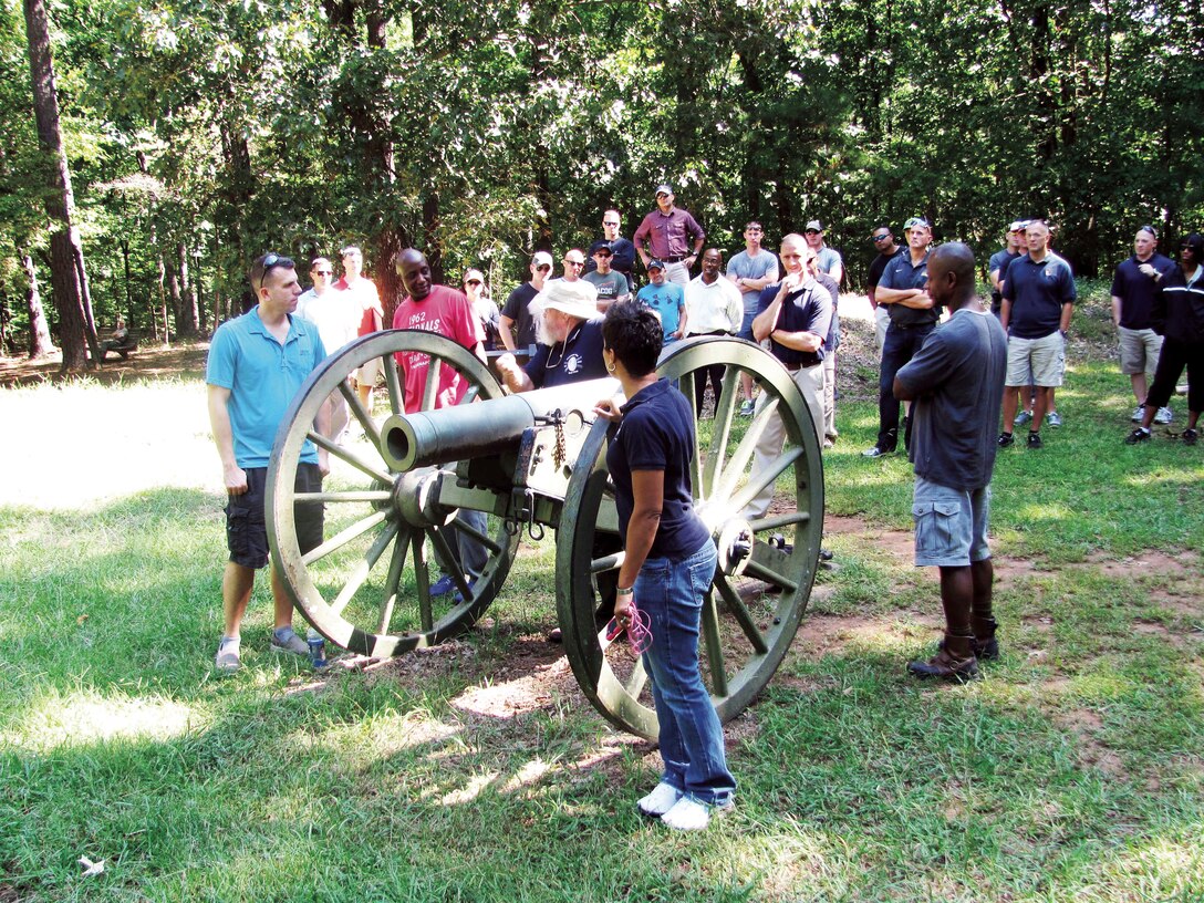 More than 50 Marines from Marine Corps Logistics Command participate in a professional military education event, recently, at Kennesaw Mountain National Battlefield Park, Kennesaw, Ga. The event was led by the park’s retired historian and designated tour guide, Willie “Swampy” Johnson, with the hat, standing next to the cannon.                  
