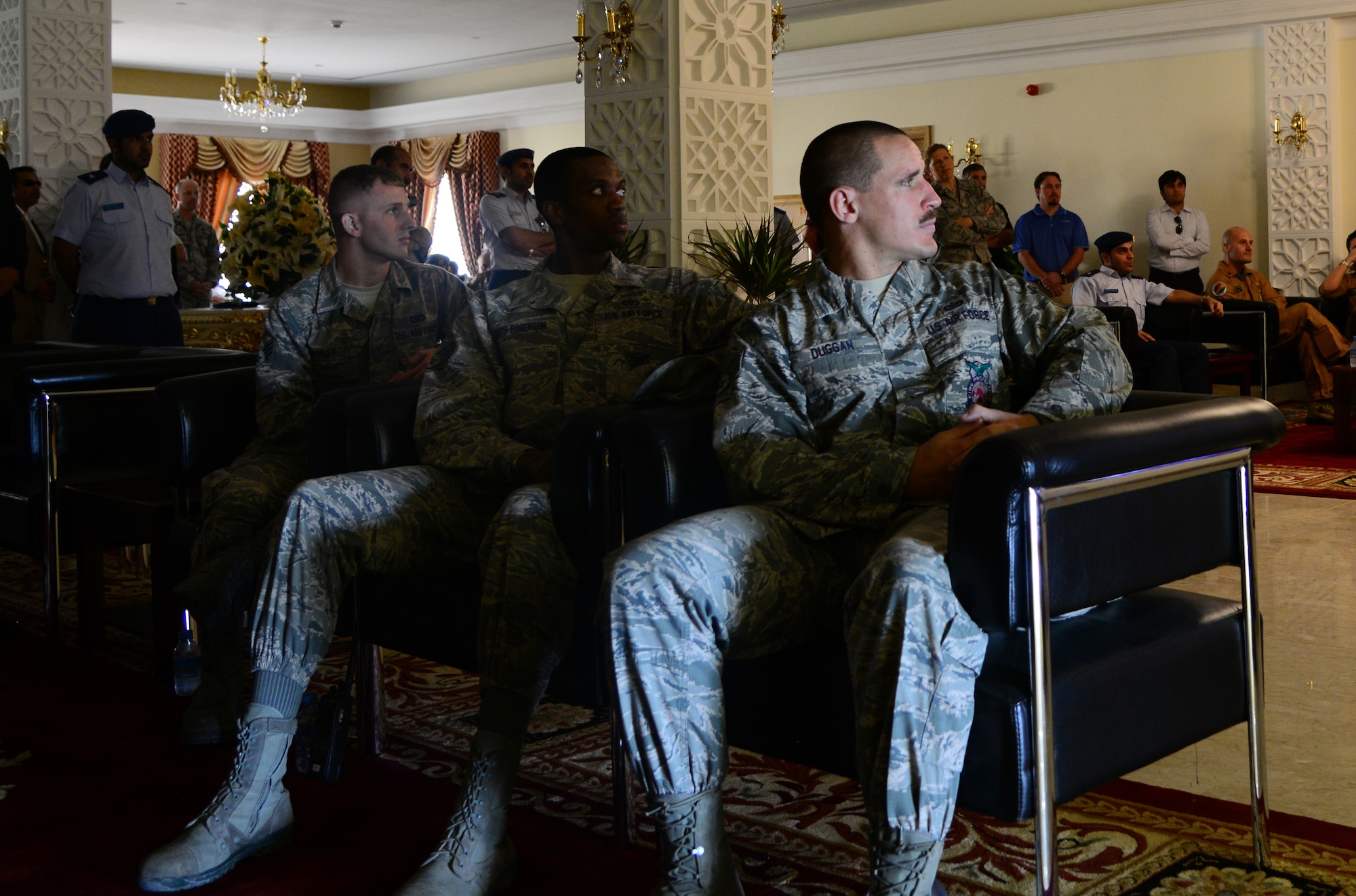 U.S. Air Force firefighters from the 379th Expeditionary Civil Engineer Squadron watch a video about the C-17 Globemaster III during the Qatar Emiri Air Force’s Air Lift Wing’s C-17 5th year anniversary ceremony Nov. 7, 2014, at Al Udeid Air Base, Qatar. During this ceremony, the firefighters were presented with certificates of appreciation for their help in putting out a C-17 fire on Sept. 6, here. (U.S. Air Force photo by Senior Airman Kia Atkins)