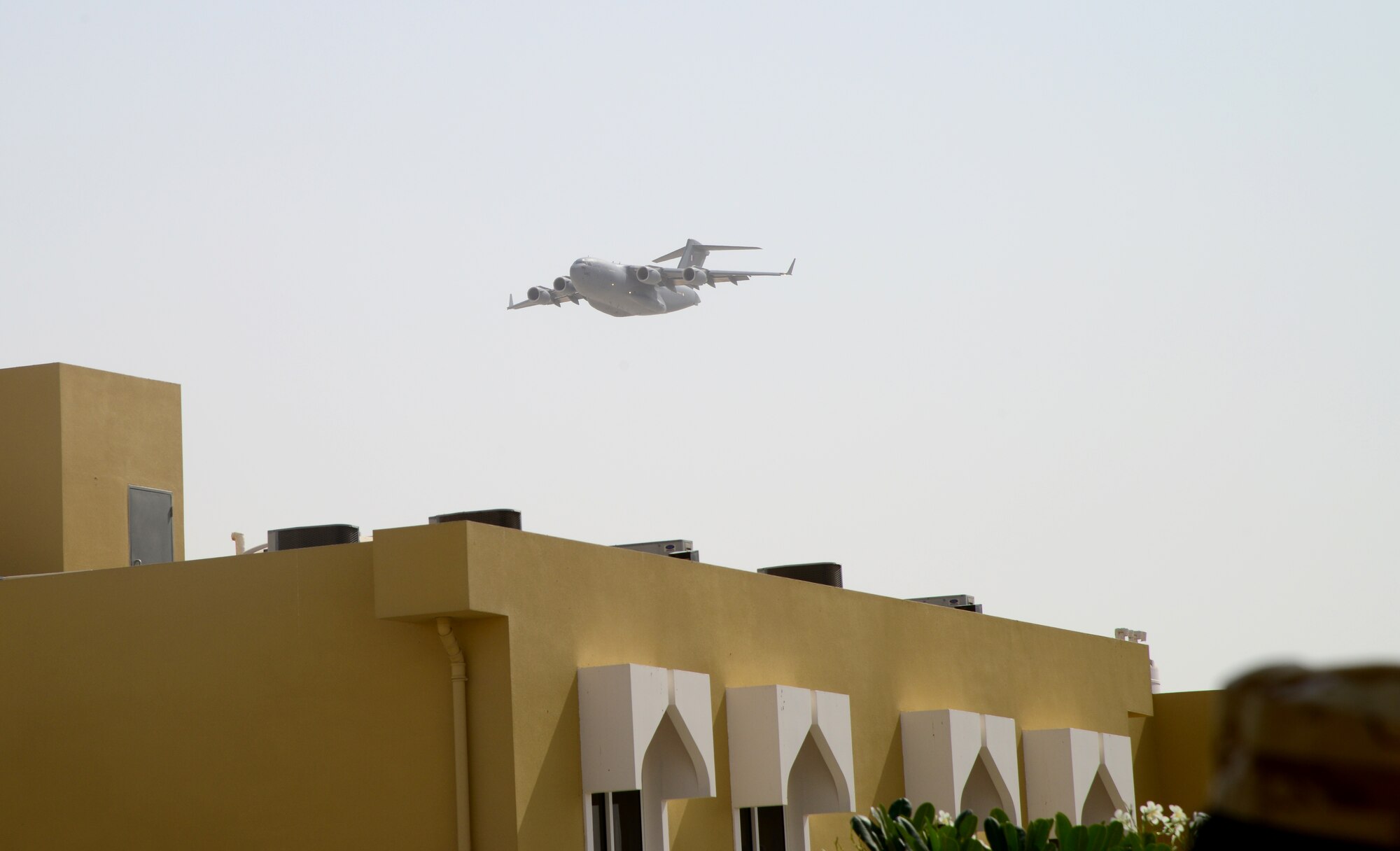A C-17 Globemaster III performs a fly over during the Qatar Emiri Air Force’s Air Lift Wing’s C-17 5th year anniversary ceremony Nov. 7, 2014, at Al Udeid Air Base, Qatar. The C-17 is the flagship to Qatar Emiri Air Force. During the ceremony, four firefighters from the 379th Expeditionary Civil Engineer Squadron received certificates for their part in putting out a C-17 fire on Sept. 6, here. (U.S. Air Force photo by Senior Airman Kia Atkins)