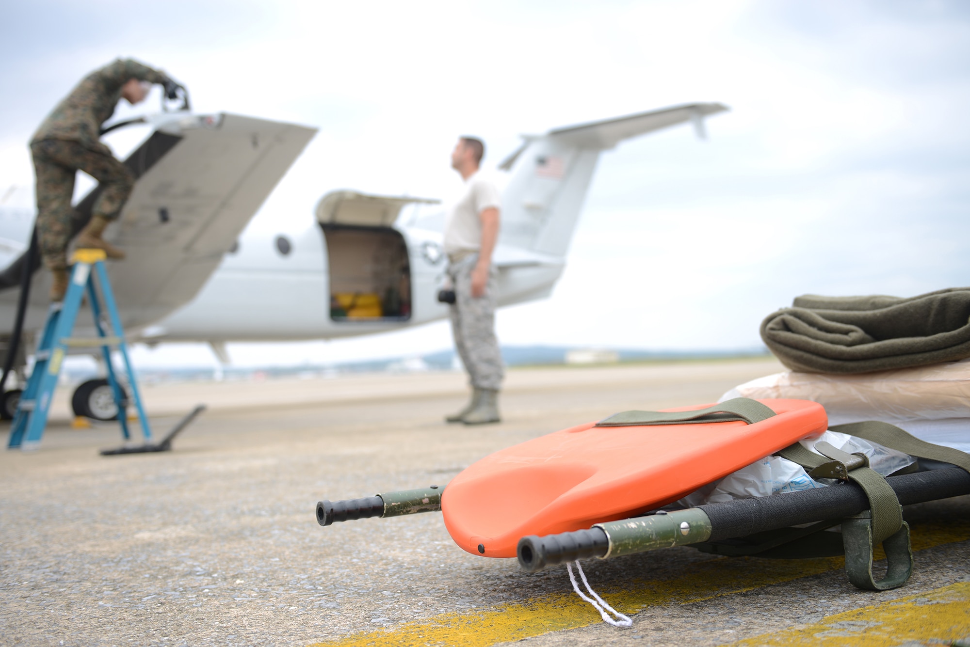 Sgt. Pedro Vazquez refuels a C-12 Huron before an aeromedical evacuation during Exercise Keen Sword 2015 at Kadena Air Base, Japan, Nov. 12, 2014. The purpose of the exercise is to improve the interoperability of Japan Self Defense Forces and U.S. forces. Vazquez is with the Marine Wing Liaison Kadena, 1st Marine Aircraft Wing. (U.S. Air Force photo by Airman 1st Class David C. Danford/Released)