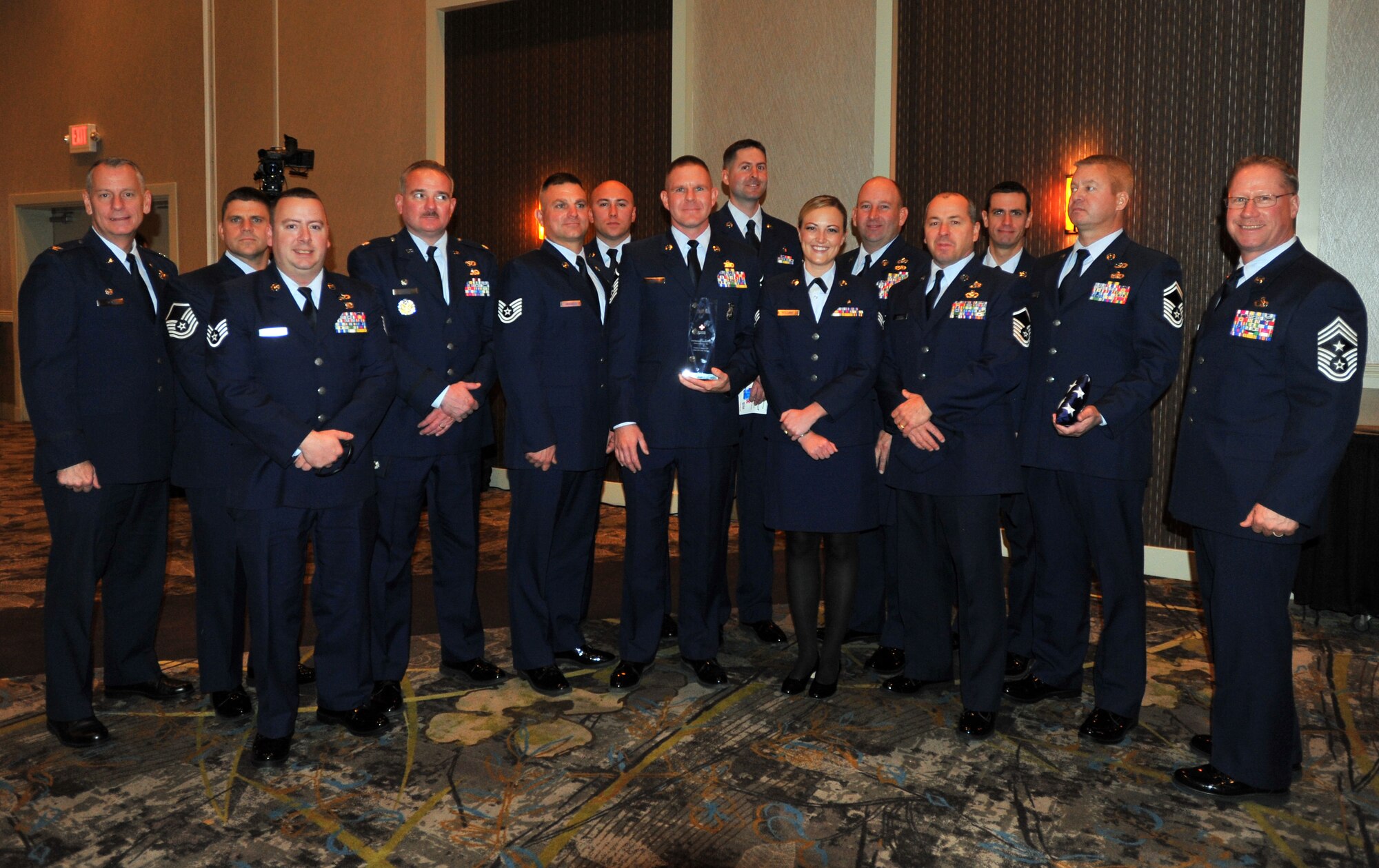 Senior Airman Nicole Holland, 141st Medical Group medical technician, stands among members of the 141st Homeland Response Force team for a group photo after receiving awards at the 11th Annual American Red Cross Honoring Hometown Heroes Luncheon Nov. 12, 2014, in Airway Heights, Wash. Holland received the Military Hero award, and the 141st Homeland Response Force Team members received the Community Partner Hero award. (U.S. Air Force photo/ Staff Sgt. Veronica Montes)