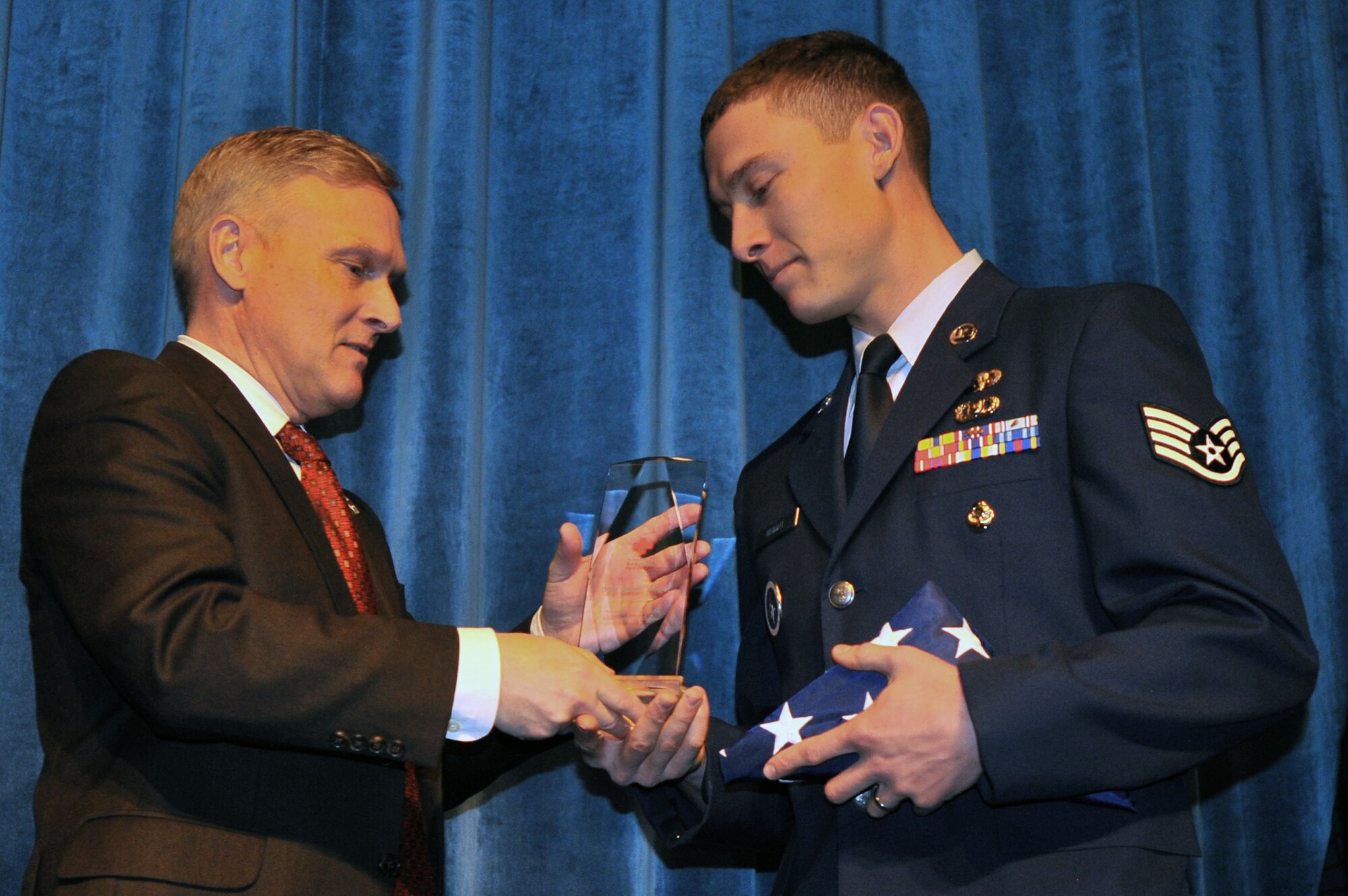 Staff Sgt. Garret Wright, 66th Training Squadron Search Evasion Resistance and Escape specialist, receives the Local Disaster Hero award at the 11th Annual American Red Cross Honoring Hometown Heroes Luncheon Nov. 12, 2014, in Airway Heights, Wash. Wright received the award for his critical assistance in helping to extricate a family from their damaged home following a major storm. (U.S. Air Force photo/Staff Sgt. Veronica Montes)