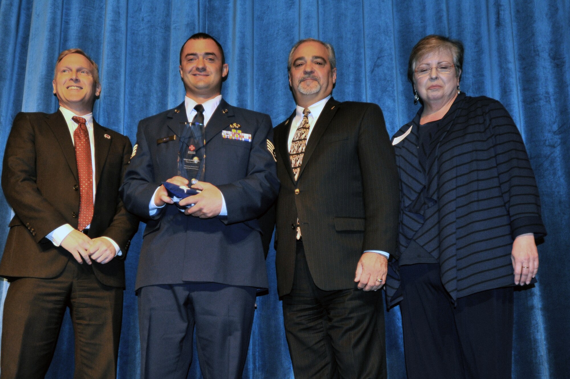 Staff Sgt. Joshua Haun, 141st Maintenance Squadron integrated electronics technician, receives the Water Rescue Hero award at the 11th Annual American Red Cross Honoring Hometown Heroes Luncheon Nov. 12, 2014, in Airway Heights, Wash. Haun received the Water Rescue Hero award for his immediate decisive actions in rescuing two potential drowning victims in Silver Lake, Wash. (U.S. Air Force photo by Staff Sgt. Veronica Montes)