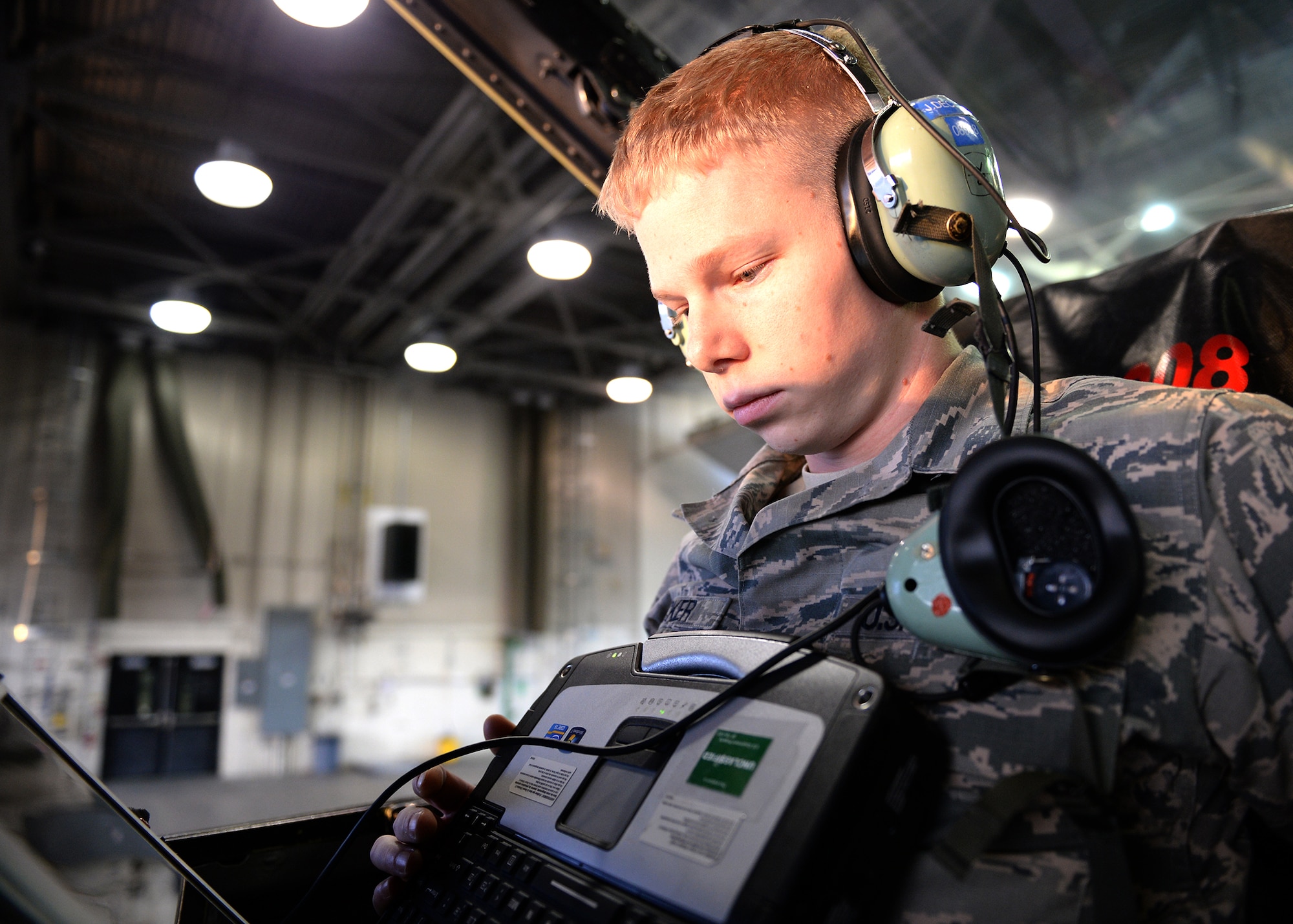 U.S. Air Force Senior Airman Jarrod Decker, a 354th Aircraft Maintenance Squadron engine technician, looks at technical orders while sitting in the cockpit of an F-16 Fighting Falcon fighter aircraft during an engine test at Eielson Air Force Base, Alaska, Nov. 12, 2014. Technicians complete the test after a safety walk around of the jet to ensure the airframe is safe for pilots. (U.S. Air Force photo by Staff Sgt. Shawn Nickel/Released)