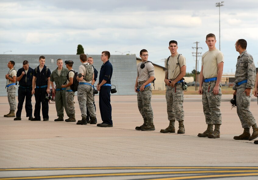 Dyess Airmen from the 7th Maintenance Group wait to perform a Foreign Object Debris (FOD) walk on the flight line Nov. 3, 2014, at Dyess Air Force Base, Texas.  Standing in this type of formation is done to keep consistency during FOD walks. (U.S. Air Force photo by Airman 1st Class Kedesha Pennant/Released)
