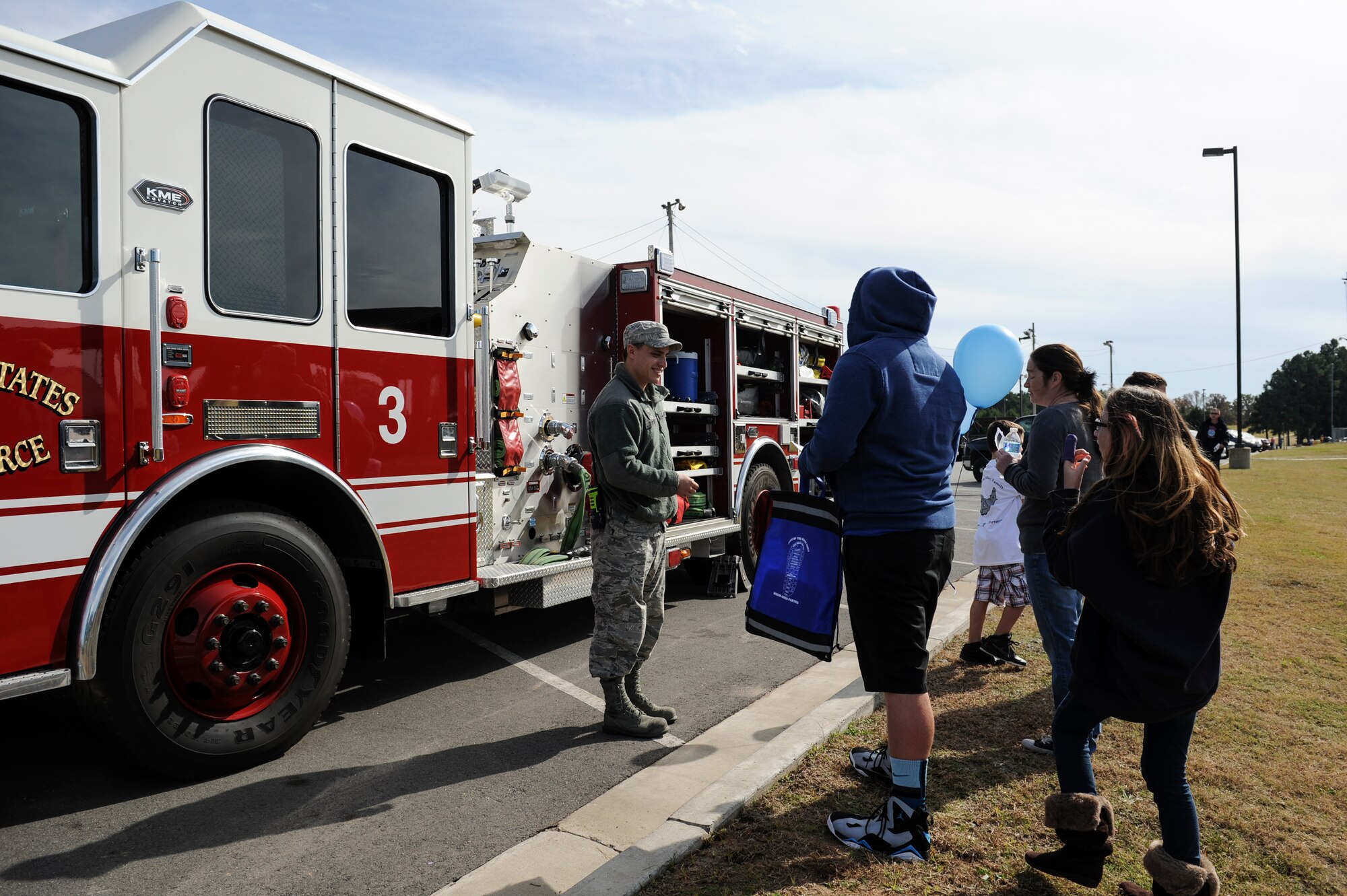 Staff Sgt. Peter Beyer, a 19th Civil Engineer Squadron firefighter crew chief, signs off on scavenger hunt checklists during the Month of the Military Family event Nov. 8, 2014, at Little Rock Air Force Base, Ark. The event, hosted by the Airman and Family Readiness Center, offered prizes and incentives for visiting all the booths and events offered throughout the day. (U.S. Air Force photo by Staff Sgt. Jessica Condit)