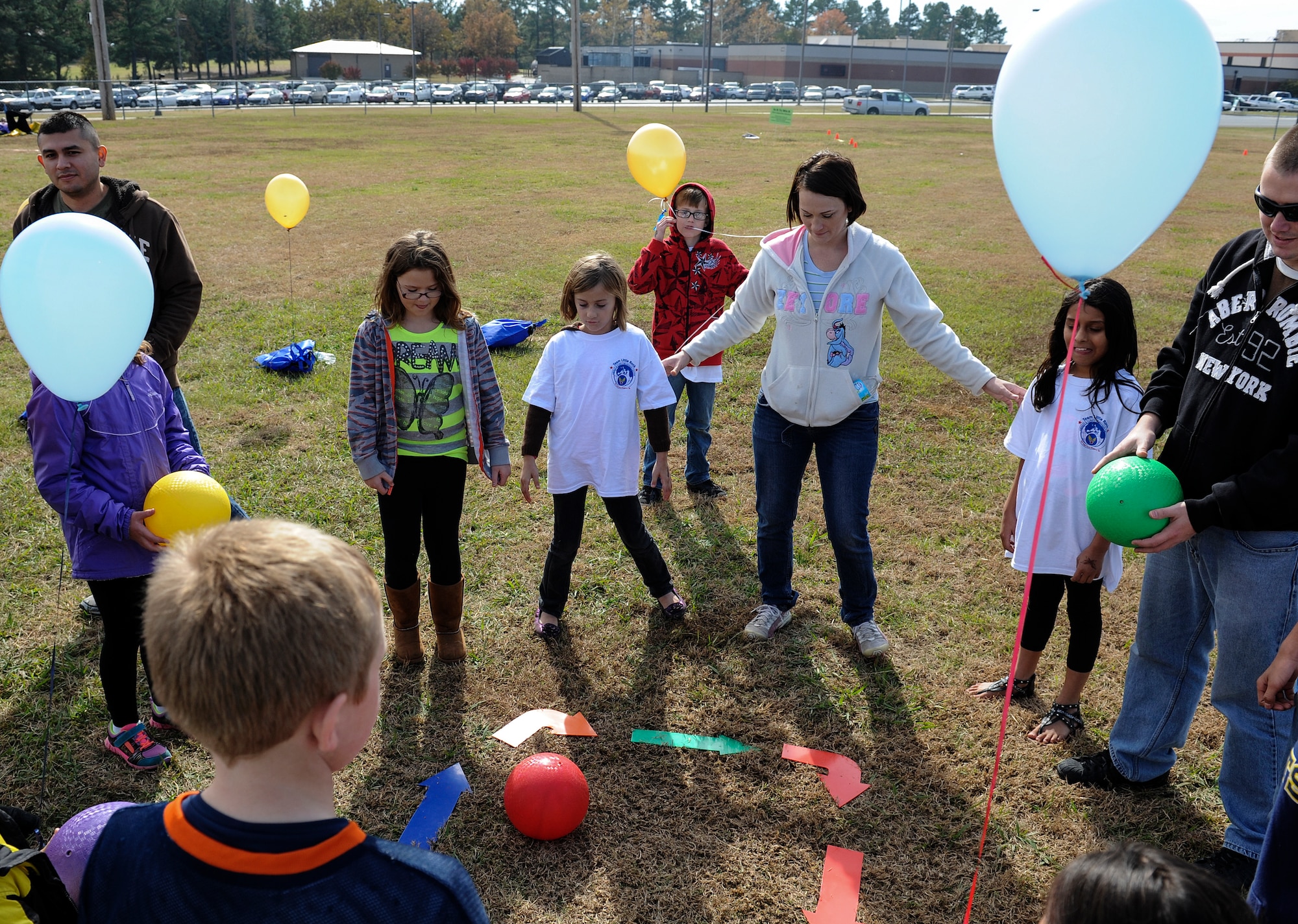 Families get ready to participate in the Wonderball game during the Month of the Military Family event Nov. 8, 2014, at Little Rock Air Force Base, Ark. The game was part of the "In it to Win It" course which consisted of five courses in order to complete the scavenger hunt checklist. (U.S. Air Force photo by Staff Sgt. Jessica Condit)