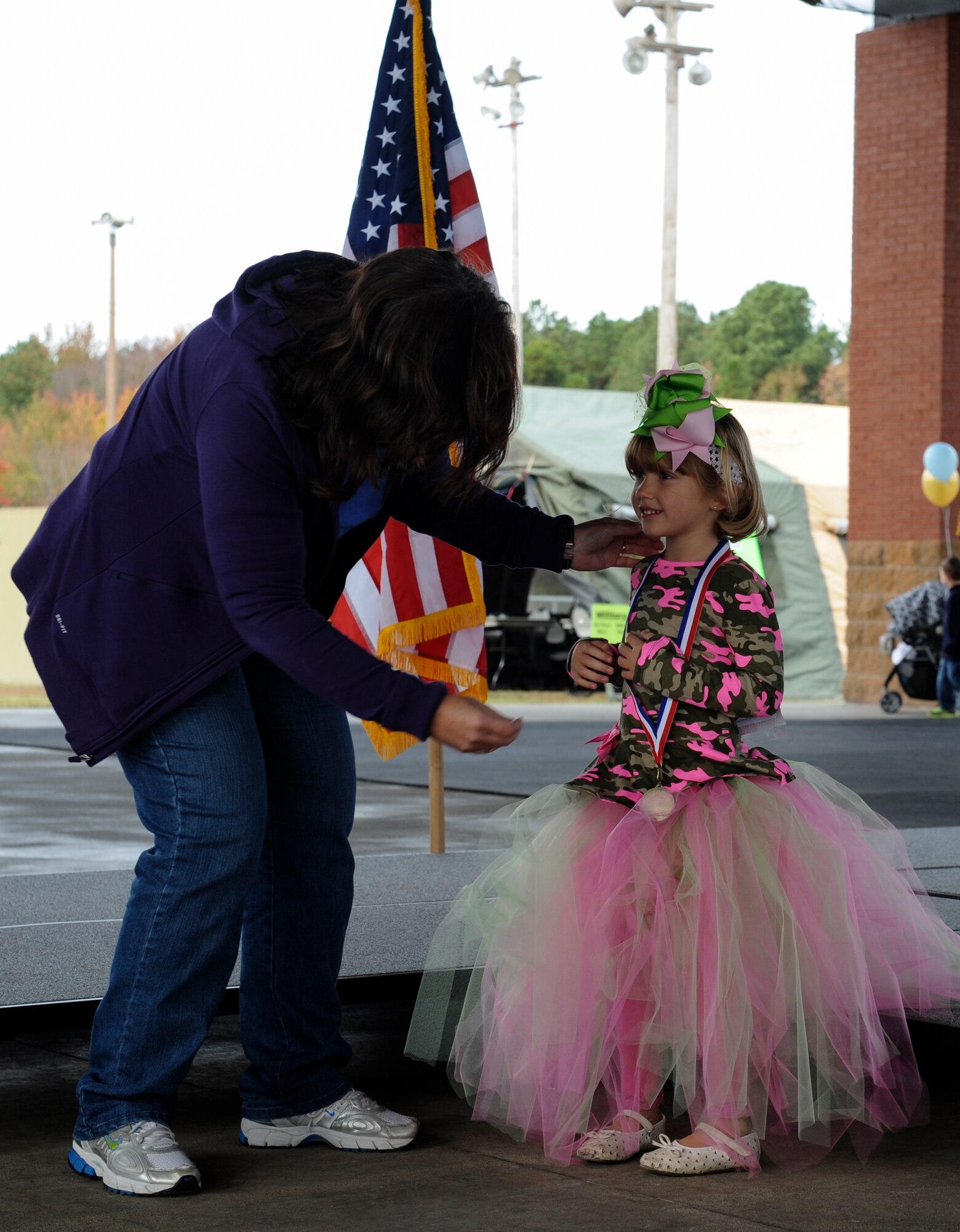 Arianna receives a medal after participating in the Littlest Warrior Contest during the Month of the Military Family event Nov. 8, 2014, at Little Rock Air Force Base, Ark. Arianna won the pageant in her age group at the event. (U.S. Air Force photo by Staff Sgt. Jessica Condit)