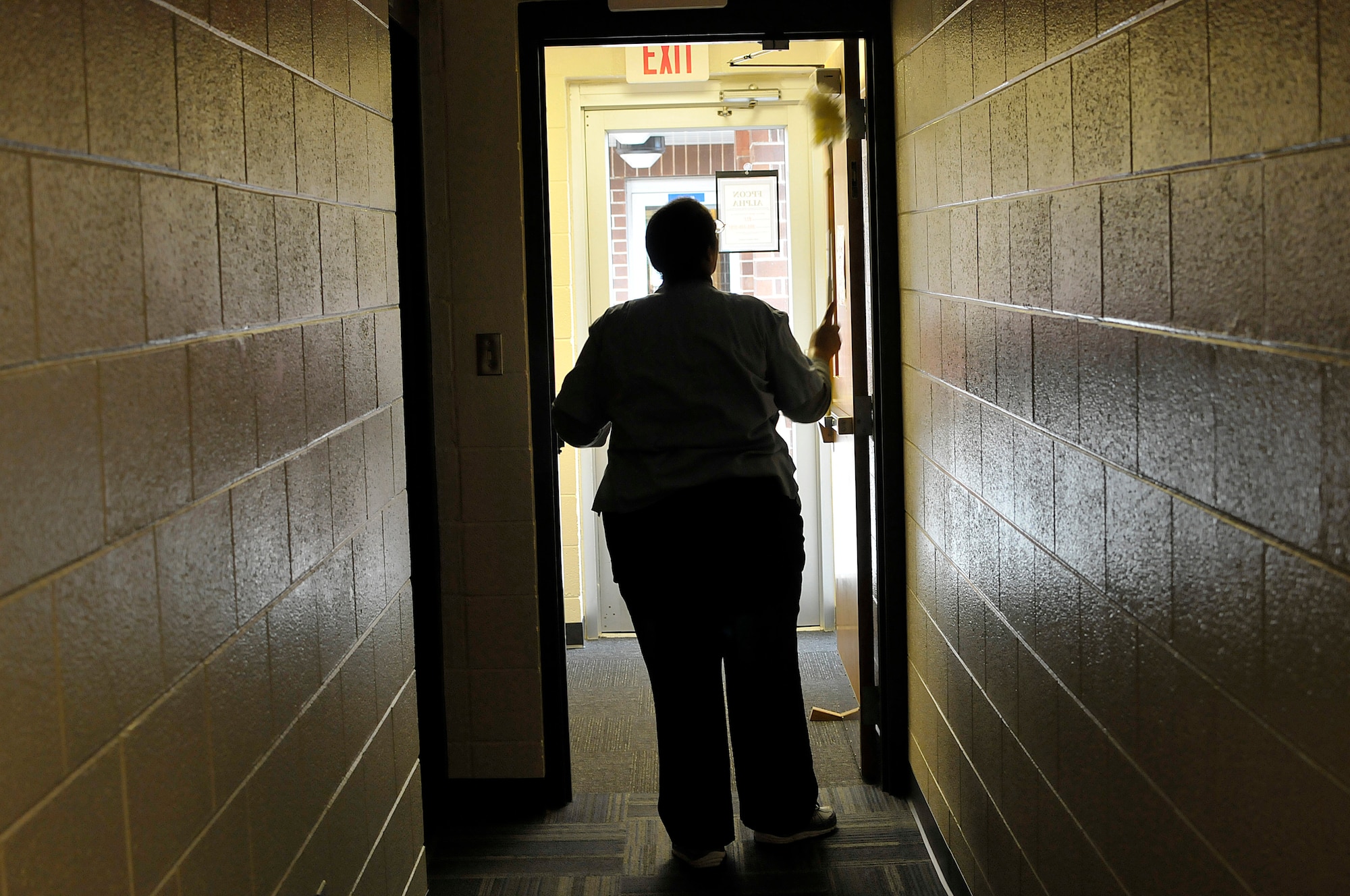 MCGHEE TYSON AIR NATIONAL GUARD BASE, Tenn. - Each of the multilevel billeting buildings' floors has a lounge, laundry room and hallways to maintain. Mildred Anthony dusts into the hallway here Nov. 7, 2014, at the McGhee Tyson Inn. (U.S. Air National Guard photo by Master Sgt. Mike R. Smith/Released)