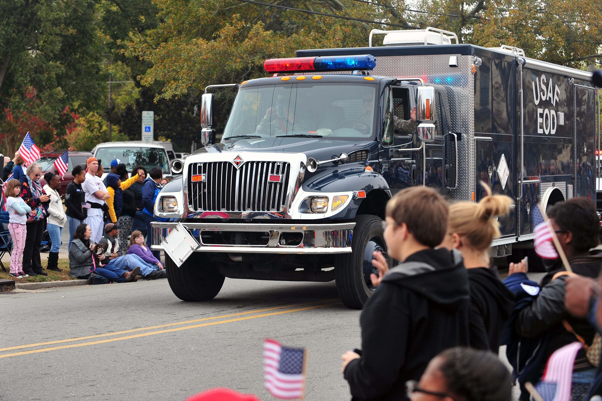 Members of the 4th Civil Engineer Squadron explosive ordnance disposal flight drive through the Veterans Day parade in Goldsboro, North Carolina, Nov. 11, 2014. Hundreds of people lined the streets to witness the parade to show support for all service members. (U.S. Air Force photo/Senior Airman John Nieves Camacho)