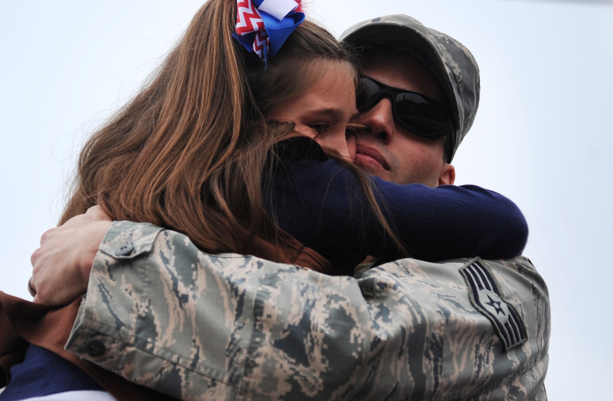 Staff Sgt. Robert Church, 8th Aircraft Maintenance Squadron, Kunsan Air Base, Republic of Korea, embraces his daughter during the Veterans Day parade in Goldsboro, North Carolina, Nov. 11, 2014. Church’s daughter was unaware her father would be home for Thanksgiving and burst into tears when he surprised her in front of the reviewing stand. (U.S. Air Force photo/Senior Airman Ashley J. Thum)