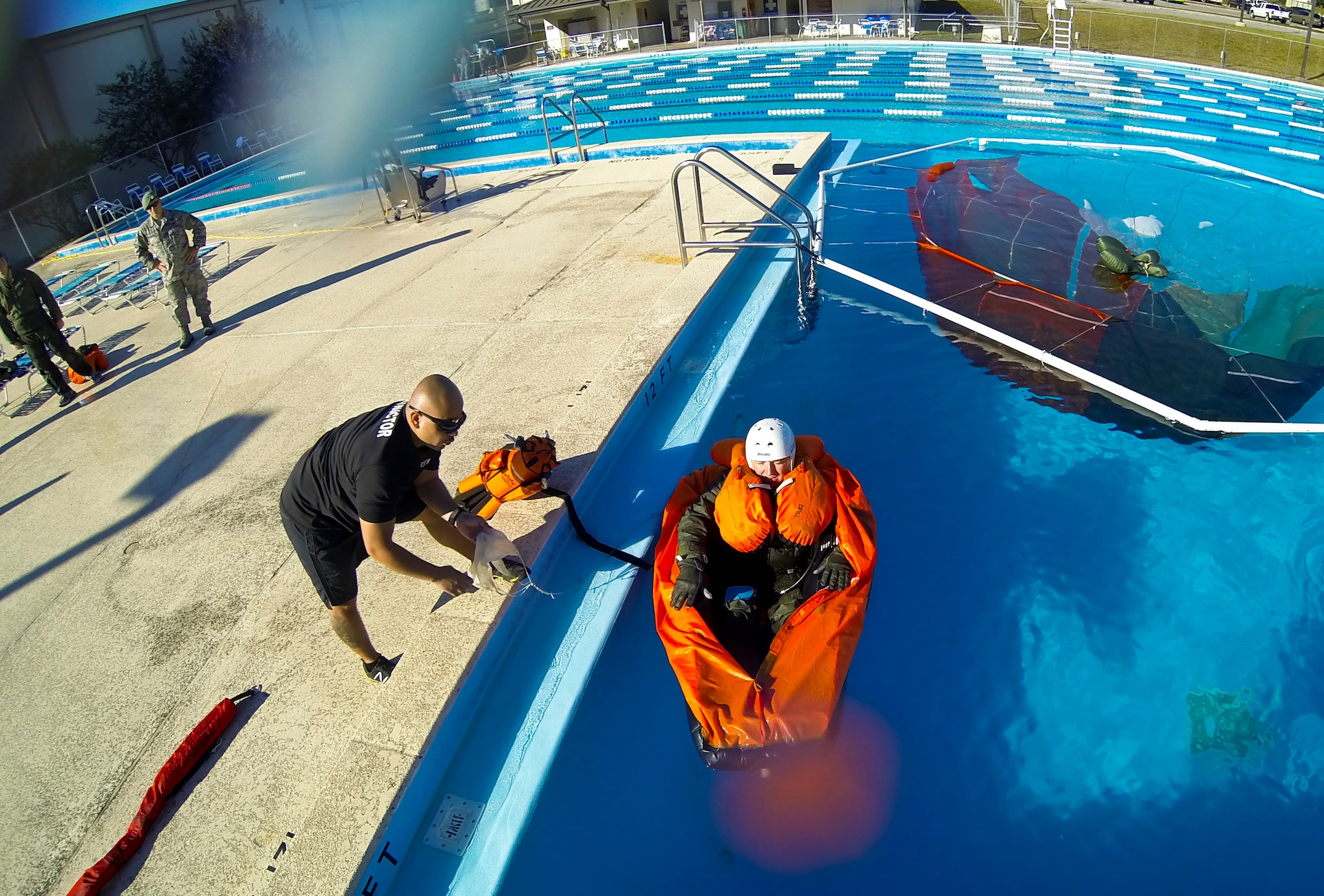 Staff Sgt. Edwin Portan, 33rd Operations Support Squadron F-35 Lightning II aircrew flight equipment continuation training instructor, questions Lt. Col. Ben Aronhime, 56th Training Squadron F-35A Lightning II pilot, about proper procedures while in a life raft during evaluations at a water survival class on Eglin Air Force Base, Fla., Oct. 31, 2014. Pilots attending F-35 water survival training are placed in simulated scenarios to provide them with the knowledge they need if they were to eject over water.  The 33rd Operations Support Squadron F-35 Lightning II aircrew flight equipment shop incorporated some training elements from previous water survival training programs and developed training tools and techniques to account for the new equipment unique to the F-35 program. (U.S. Air Force photo/Staff Sgt. Marleah Robertson)